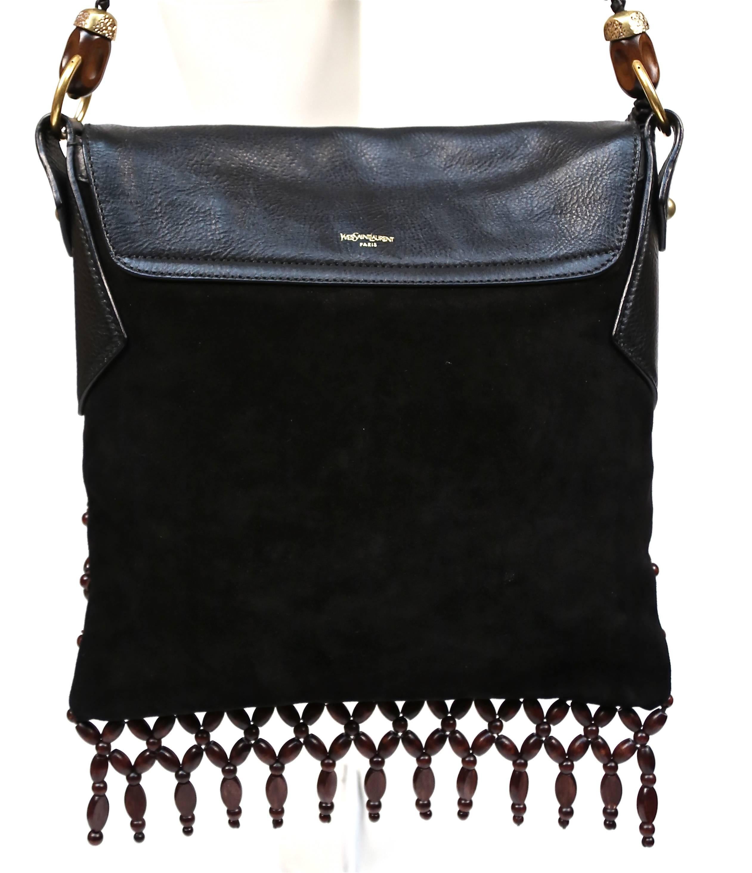 Very interesting, black suede and leather handbag with brown wooden beading and brass hardware from Yves Saint Laurent dating to the 2005 as designed by Tom Ford for Yves Saint Laurent. Approximate measurements: 12