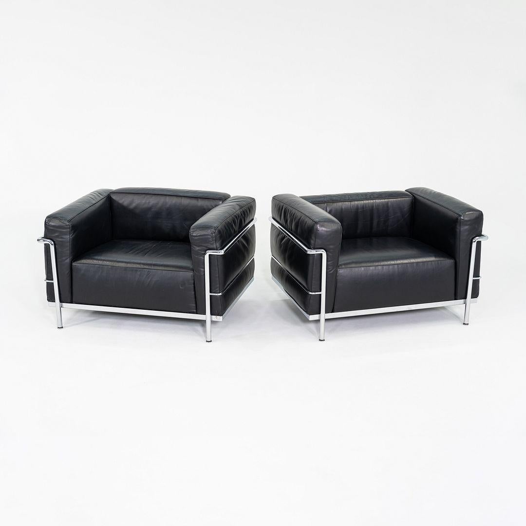 These are LC3 Fauteuil Grand Confort, Grand Modele Lounge Chairs, initially designed by Le Corbusier, Pierre Jeanneret, and Charlotte Perriand in 1928. These examples date to 2006 and were produced in Italy by Cassina. They feature upholstery in