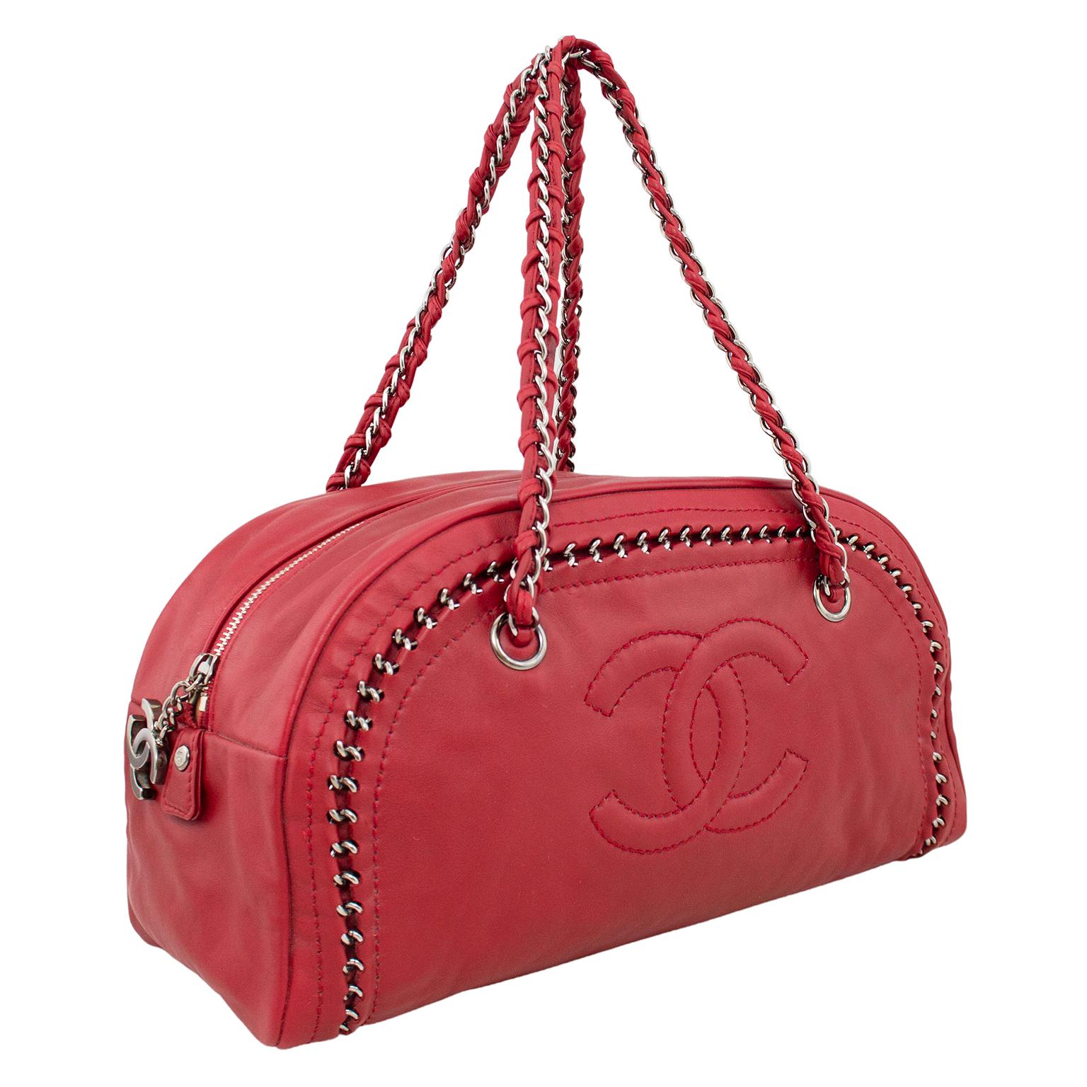 Designed in 2006 by Karl Lagerfeld, this is the Chanel Luxe Ligne bowler bag in a beautiful raspberry leather. Supple leather with silver tone embedded chain trim. Double top handles are leather with silver chain woven through. Large embossed cc