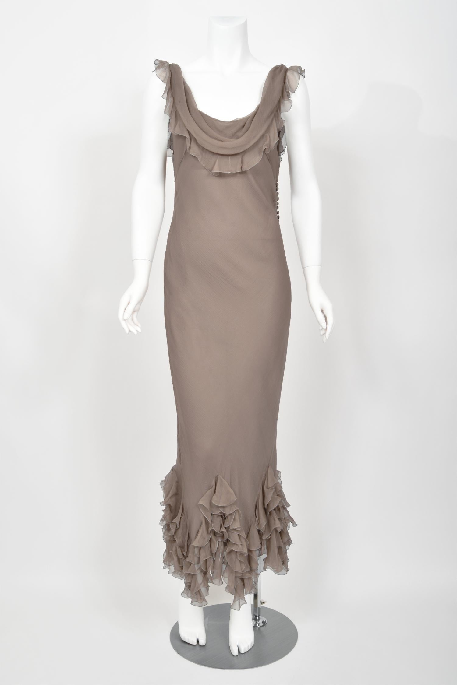 An absolutely breathtaking and highly coveted Christian Dior smoky taupe silk chiffon bias-cut gown dating back to John Galliano's epic 2006 spring/summer collection. John Galliano is widely considered one of the most innovative and influential