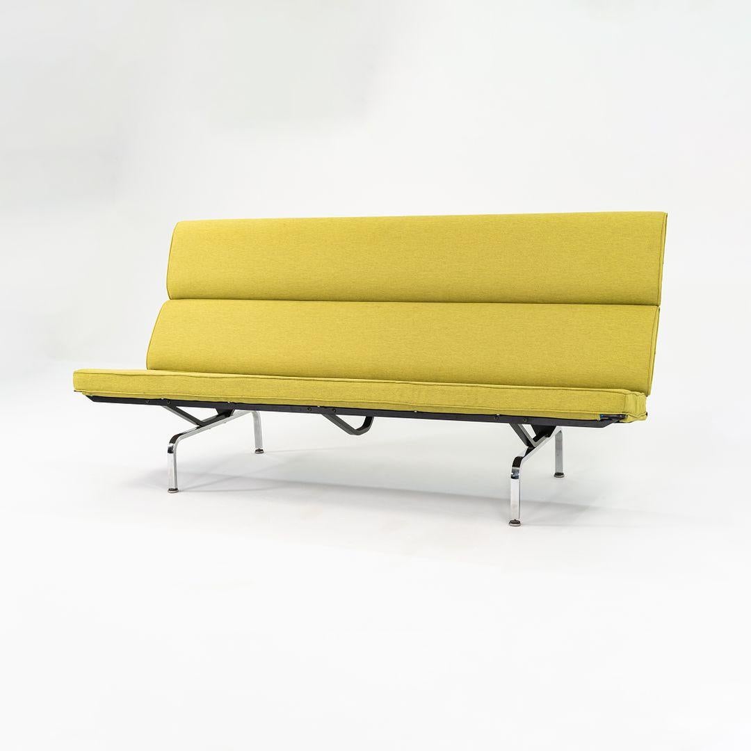This is an Eames Compact Sofa, Model S-473, initially designed by Charles and Ray Eames for Herman Miller in 1954. This particular example dates to 2006 and has been freshly reupholstered in a deep yellow fabric. It has a chromed-steel frame,