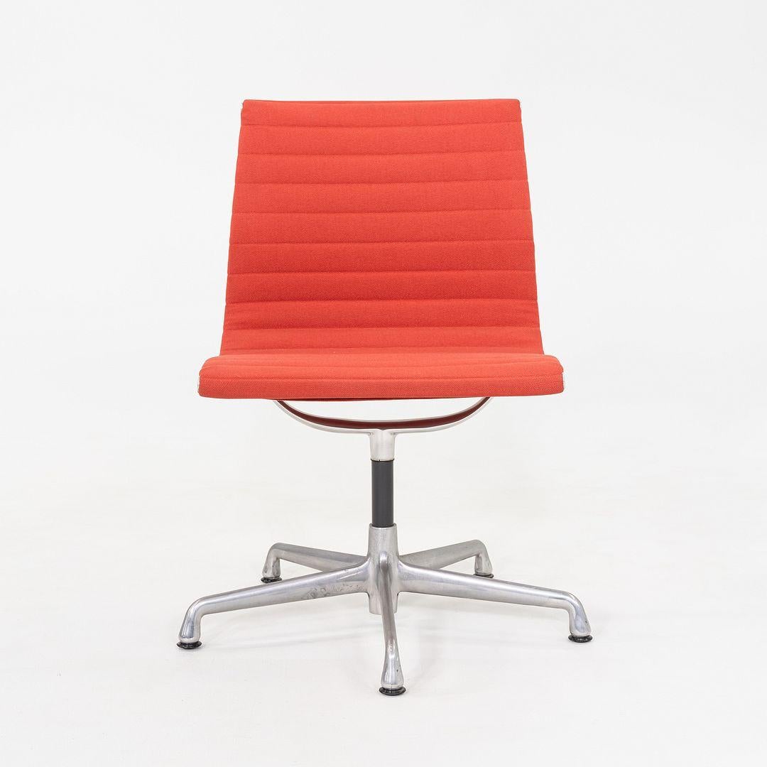This is an Eames Aluminum Group armless desk or side chair, originally designed by Ray and Charles Eames in 1958. These particular examples were produced by Herman Miller in the USA in 2006. The design features a lightweight aluminum frame with a
