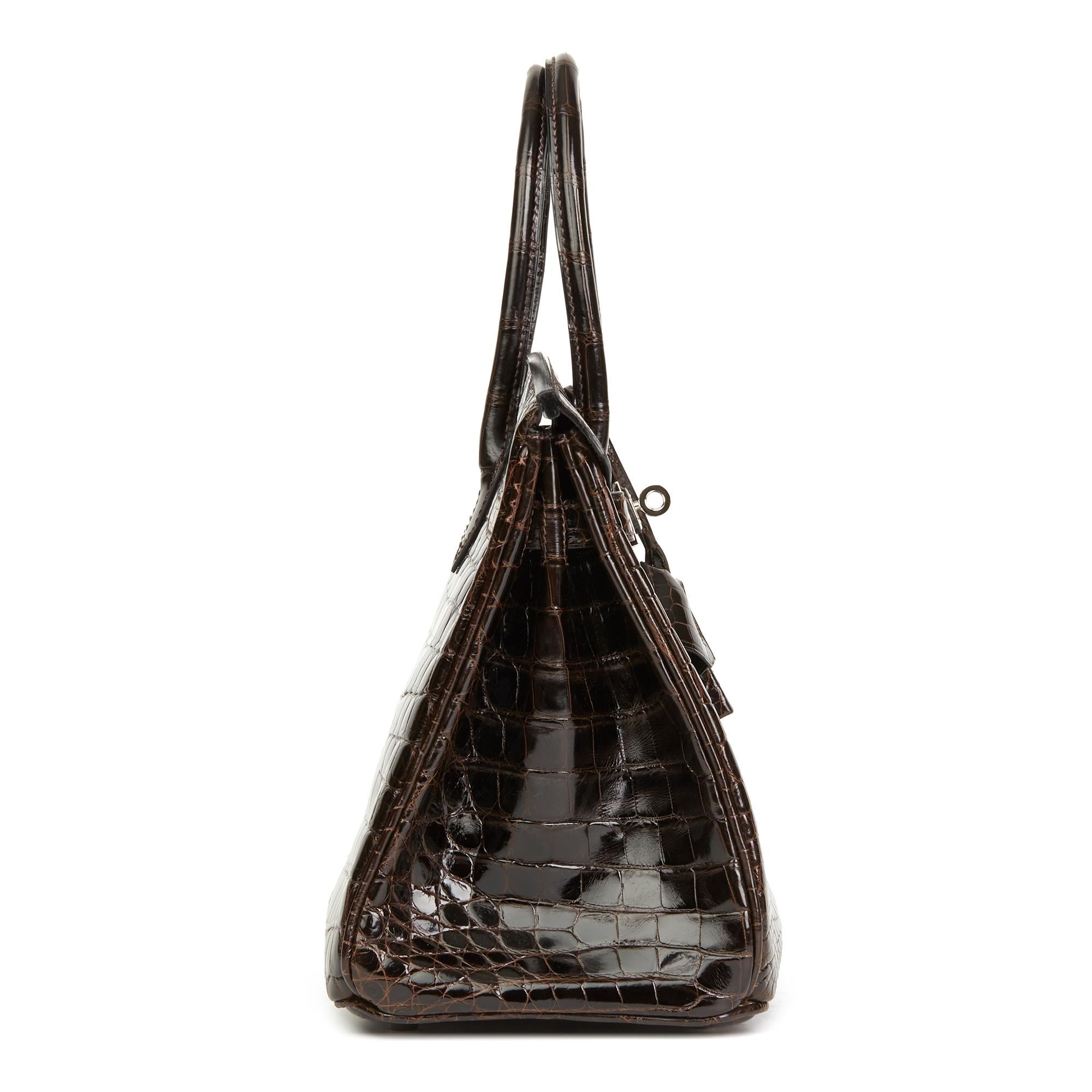 HERMÈS
Marron Fonce Shiny Niloticus Crocodile Leather Birkin 30cm

 Reference: HB2879
Serial Number: [J]
Age (Circa): 2006
Accompanied By: Hermès Dust Bag, Box, Lock, Keys, Clochette, Rain Cover, Protective Felt
Authenticity Details: Date Stamp
