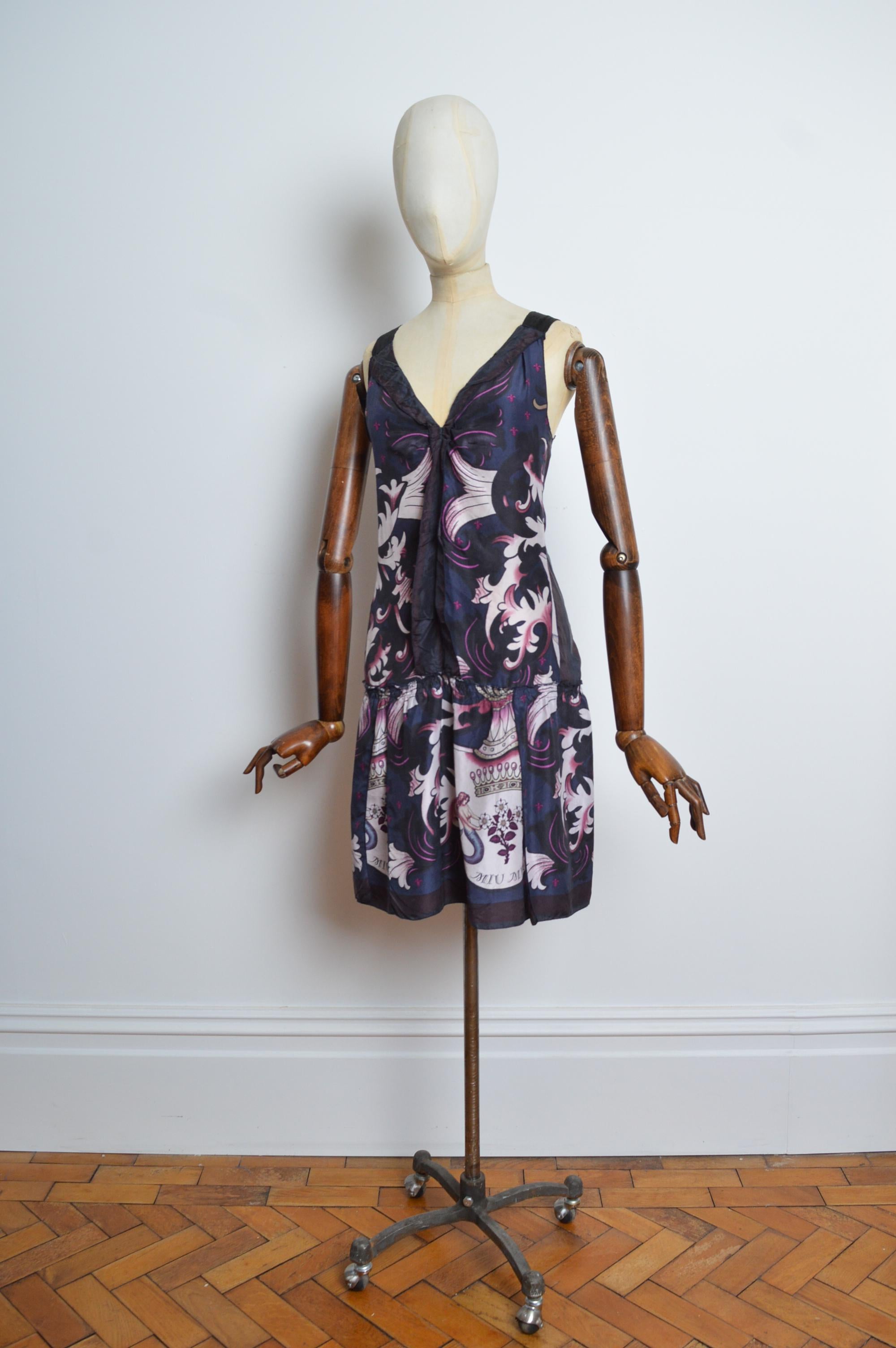 2006 MIU MIU Vintage Silk Mermaid pattern ‘Coat of arms’ Shift Mini Dress
MADE IN ITALY. 
100% Pure Silk. 
Features - iconic Archival MIU MIU print / concealed side zip / Strap shoulders / Drop waist loose silhouette. 
Size; we recommend to best fit