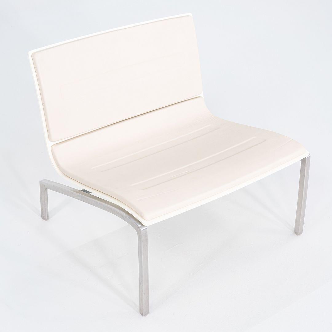 These are PL200 Lounge Chairs, originally designed by Piero Lissoni for Fritz Hansen in 2006. These examples were produced in Denmark in 2006. They chairs are comprised of a an aluminum frame and feature white leather upholstered seats. The listed
