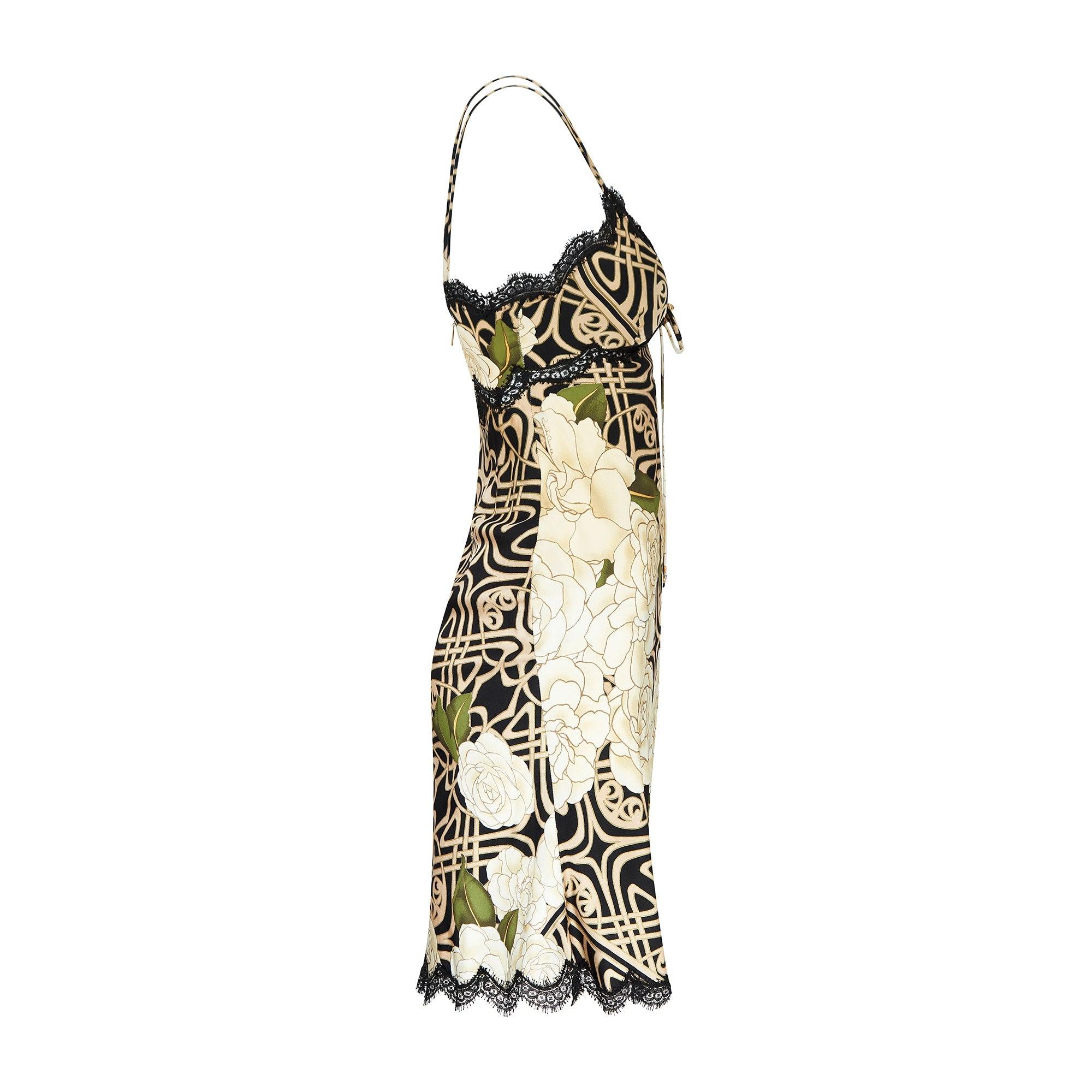 Made in Italy, this flamboyant Roberto Cavalli dress dates back to the noughties. Many signatures of Y2K fashion and of this collectable brand are present; slip-dress silhouettes, black lace trim, spaghetti straps, gold-tone metal detailing. Cut