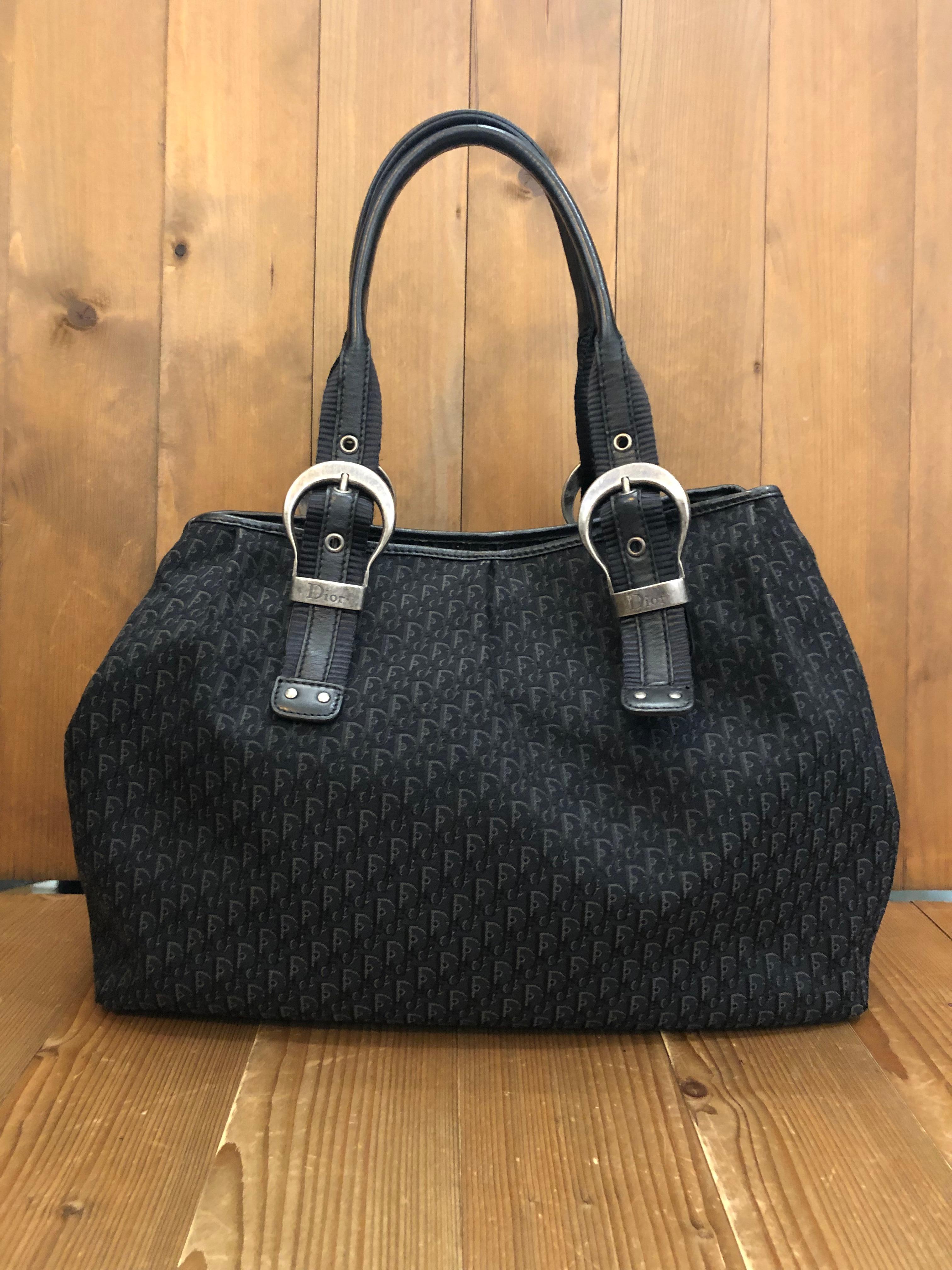 2007 Christian Dior shoulder bag in black trotter jacquard featuring double wide handles for comfort on your shoulder. Interior has one interior zip pocket to keep your belongings secured. Magnetic snap closure. Made in Italy. This bag is ideal for