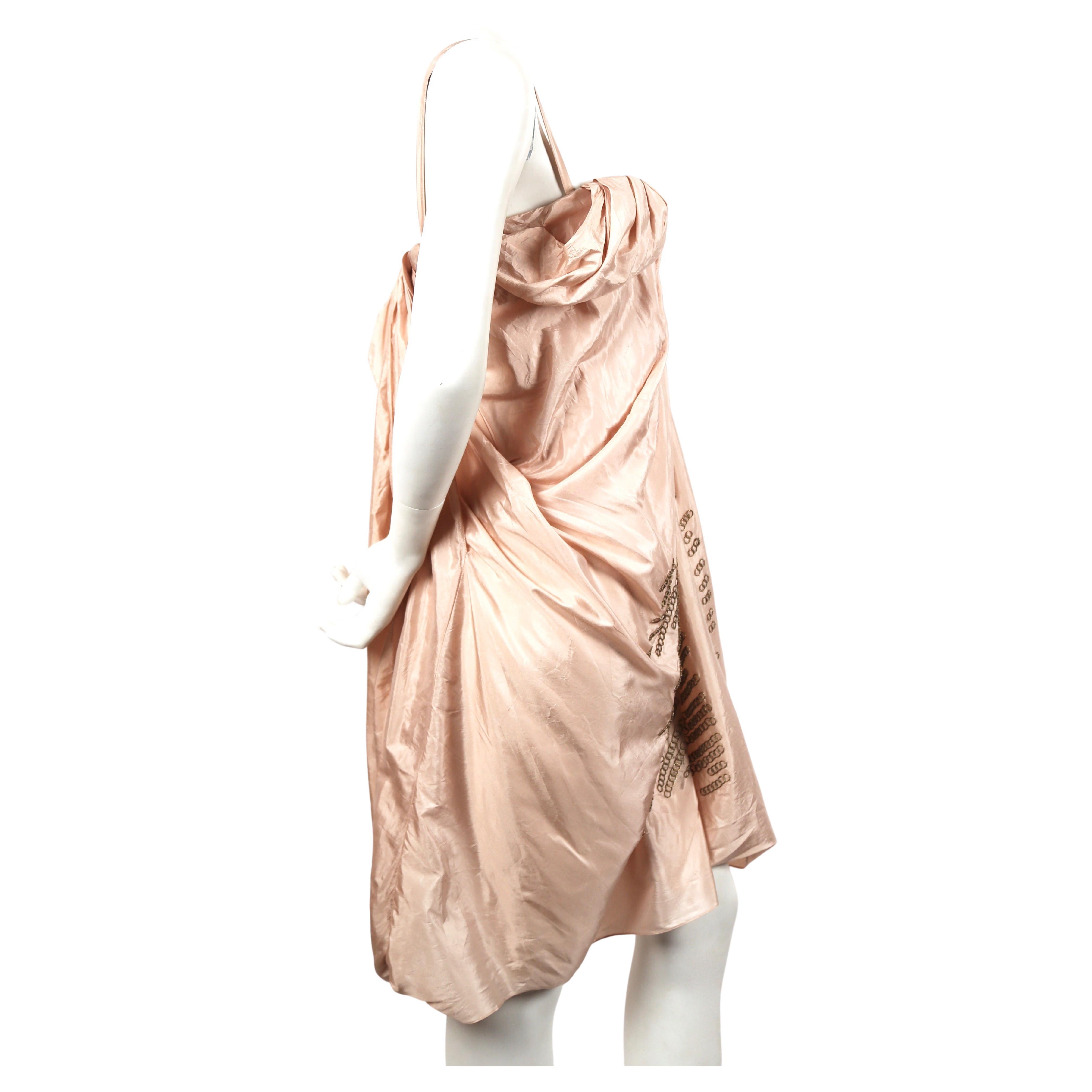 Champagne-pink, silk dress with extensive draping and hand-sewn brass ring detail designed by John Galliano for Christian Dior dating spring of 2007 exactly as seen on the 'Back to Basics' runway show. French size 38. Inner corset with light padding
