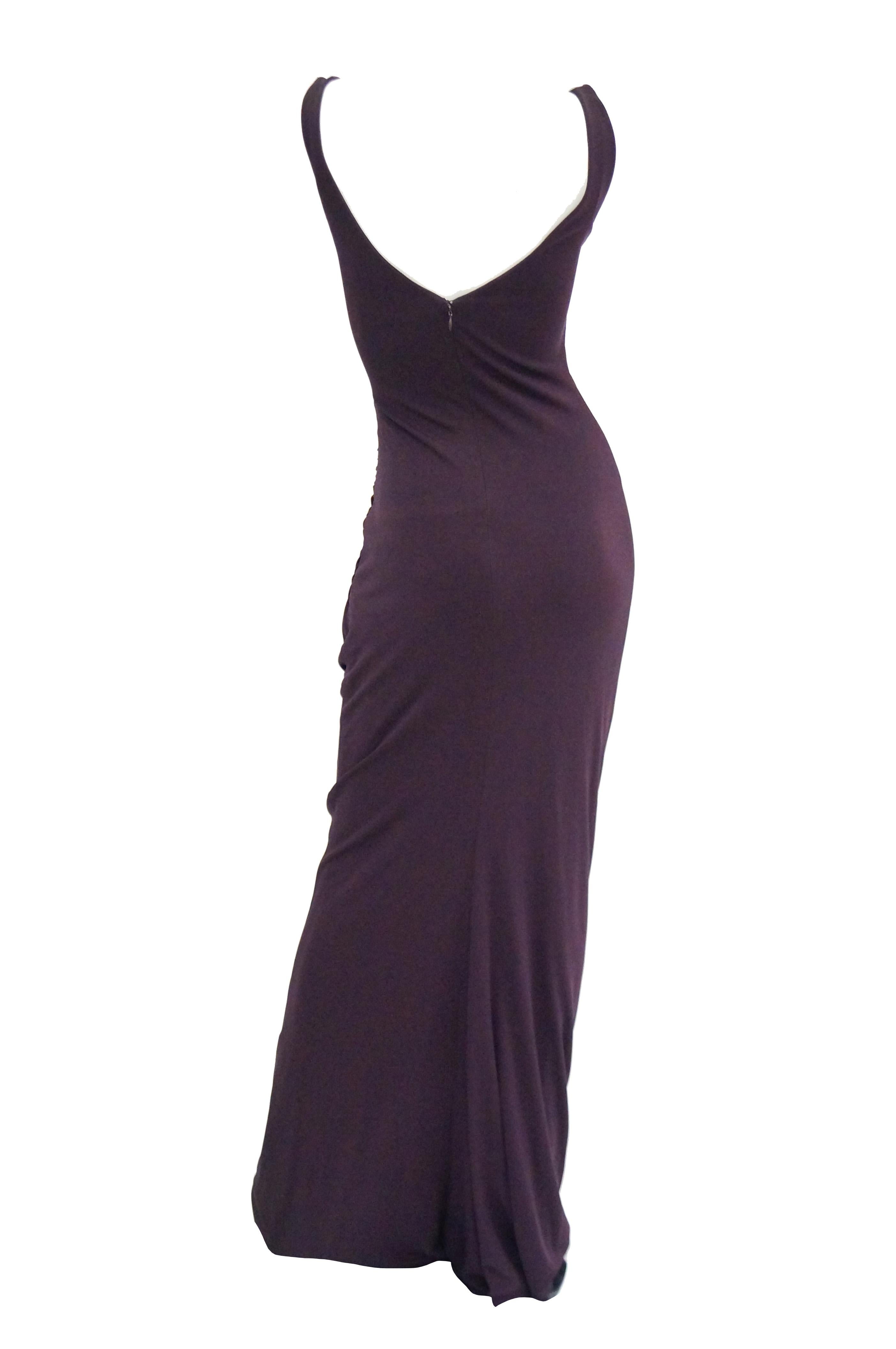 Striking evening dress by Donald Deal. This maxi length evening dress is maxi length, sleeveless with wide straps, a v - neck, and a low back. The body conforming dress is color blocked, with a panel of deep ginger orange at the front waist. The