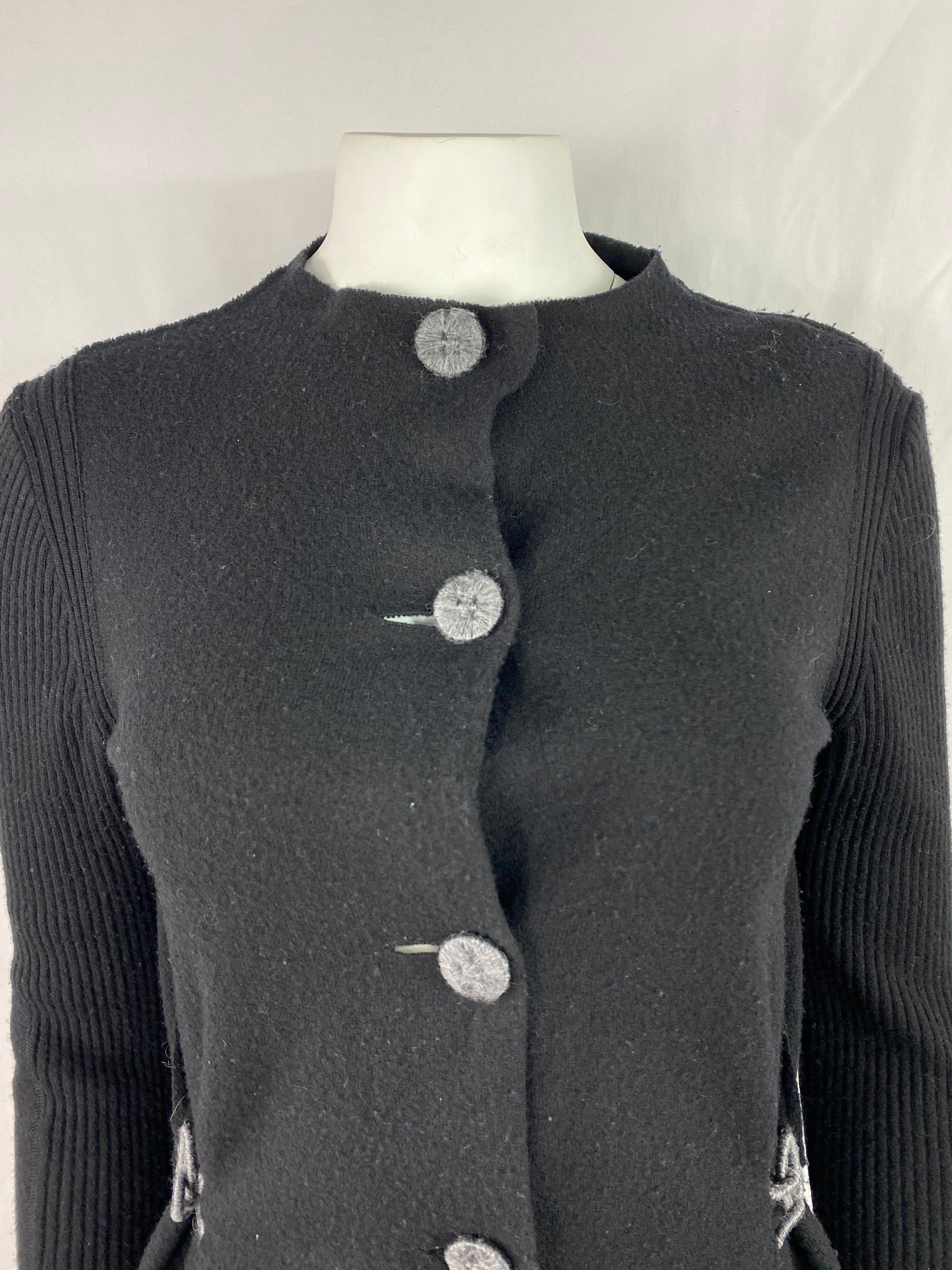 Product details:

The sweater features long sleeves, crew neck line, front large grey buttons closure, side grey hook on each side and ribbed finish on the sleeves. Made in Italy.