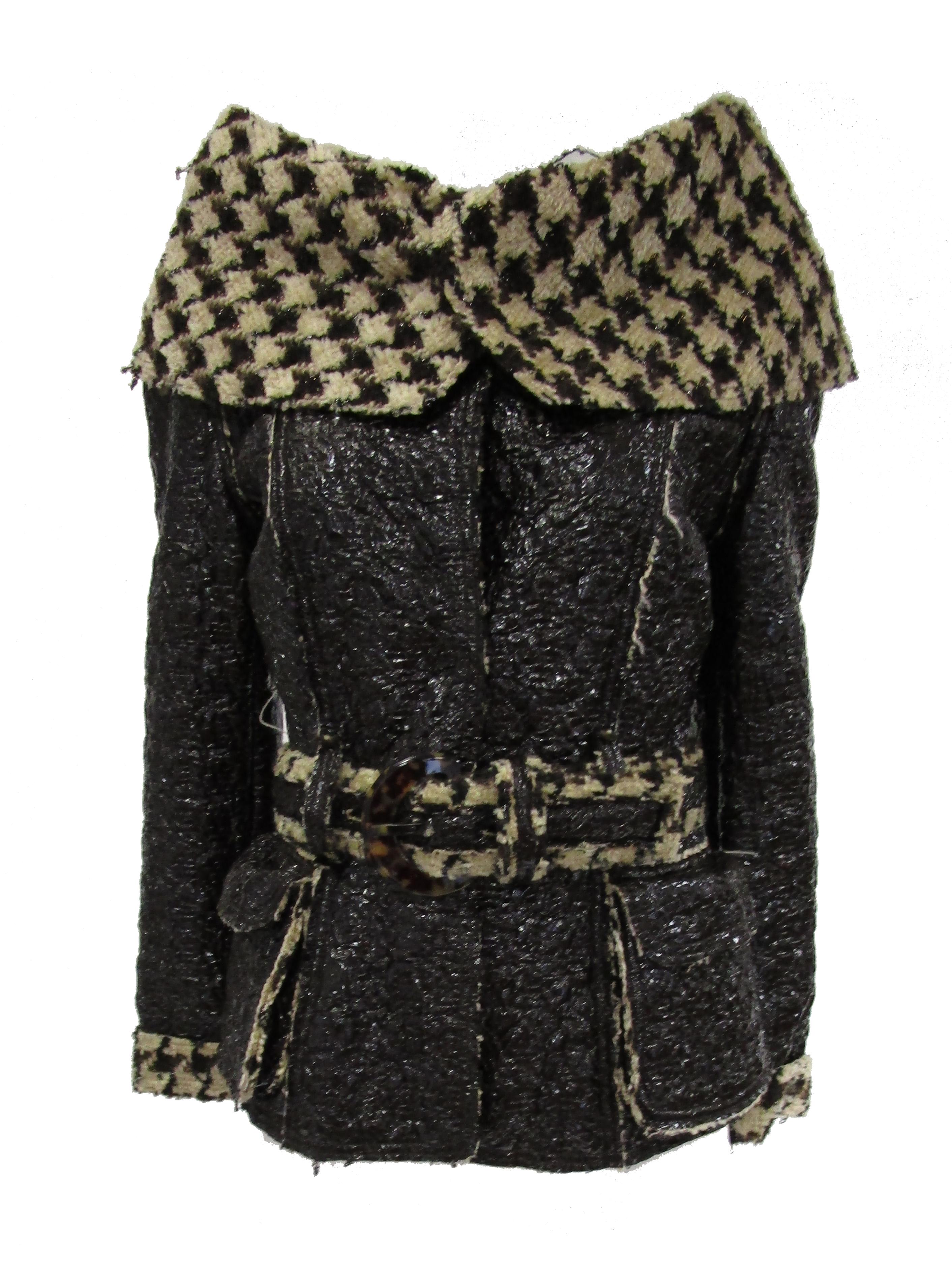 Delightful and unexpected jacket by Oscar de la Renta. This hip - length black coat features a glossy crackle coated brown fabric that is accented by a bold but supple houndstooth print on the collar. The collar is something else! It folds over the