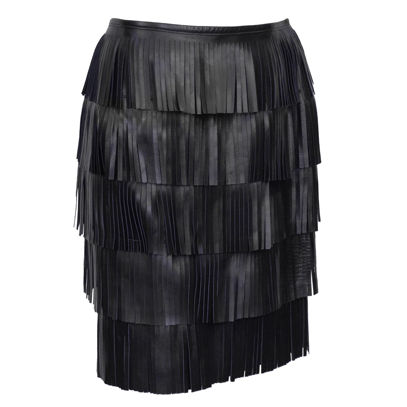 Iconic Prada Spring/Summer 2007 black leather fringe skirt. Composed of 5 tiers of leather fringe and lined in black silk this skirt is is fun and easy to wear. Zipper up the back with looped button at the top. Marked an IT 42, fits like a US 4. IN