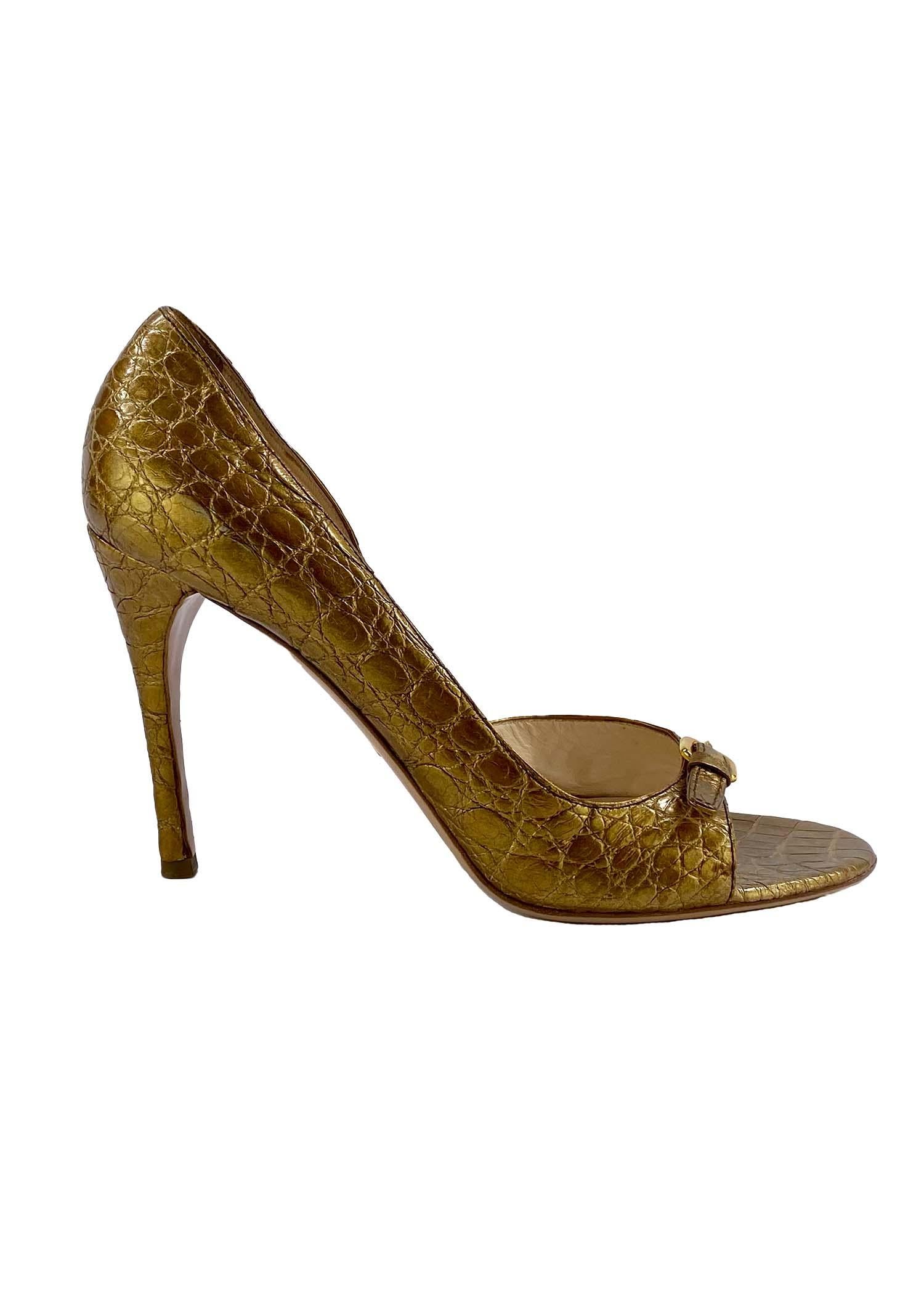 TheRealList presents: a pair of gold Prada crocodile heels created as a limited edition release to celebrate Neiman Marcus' 100th anniversary in 2007. This open-toe heel features a petite gold buckle about the toe. These heels are the perfect
