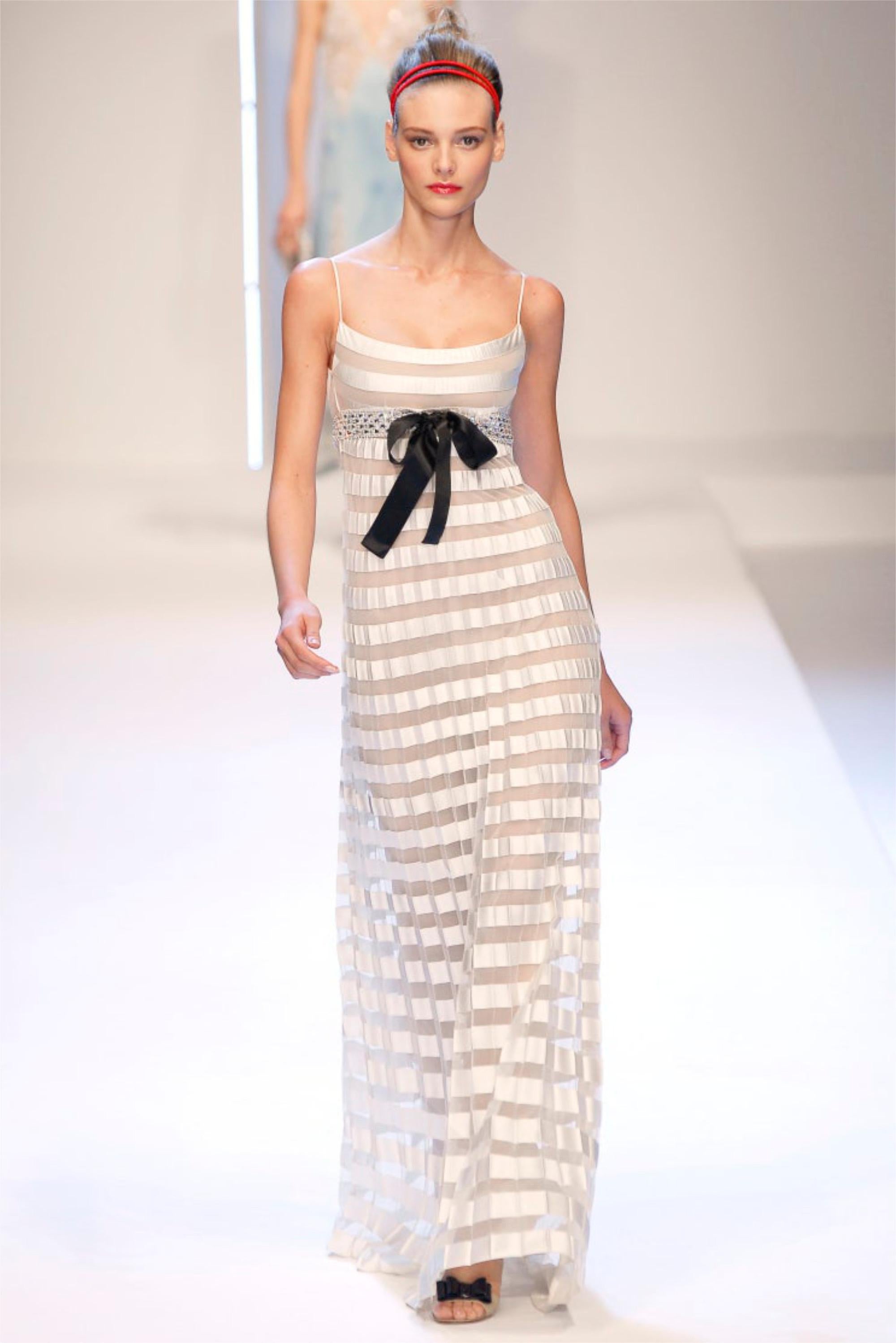 An absolutely stunning Valentino ivory silk and sheer illusion net-tulle beaded crystal gown dating back to his 2007 spring-summer collection. For over forty years, Valentino has been one of the most prominent names in fashion, creating some of the