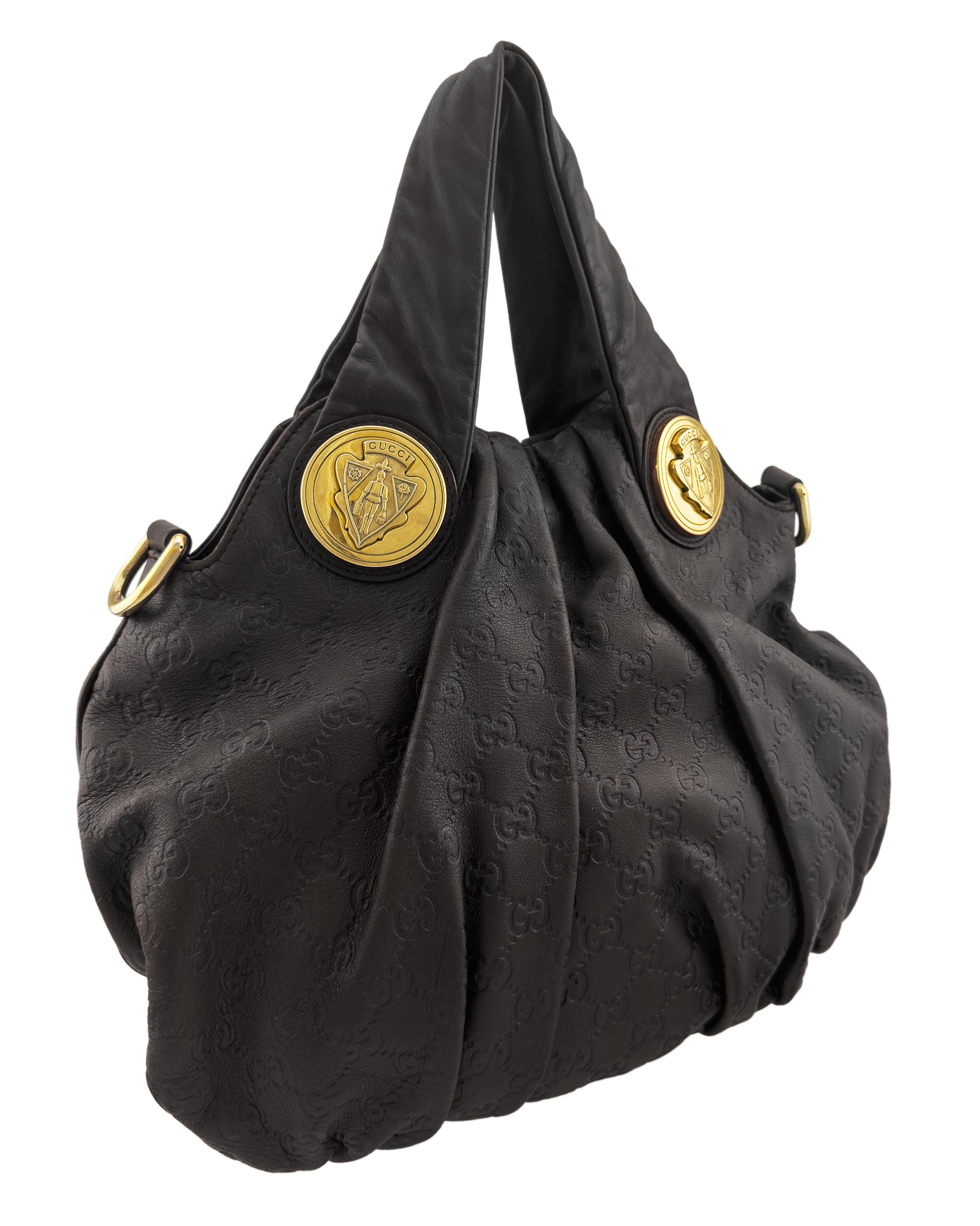 2008/2009 Gucci Hysteria hobo bag in rich dark brown Guccissima leather. Designed with soft pleating and a slouchy silhouette, it features Gucci’s iconic embossed GG monogram throughout, paired with striking oversized gold-tone medallions engraved