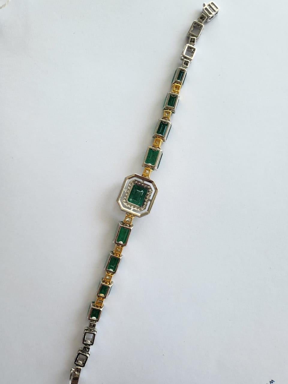 A very gorgeous and modern, Emerald Bracelet set in 18K White Gold & Diamonds. The combined weight of the Emeralds is 20.08 carats. the Emeralds are completely natural, without any treatment and is of Zambian origin. The Yellow Diamonds weight is