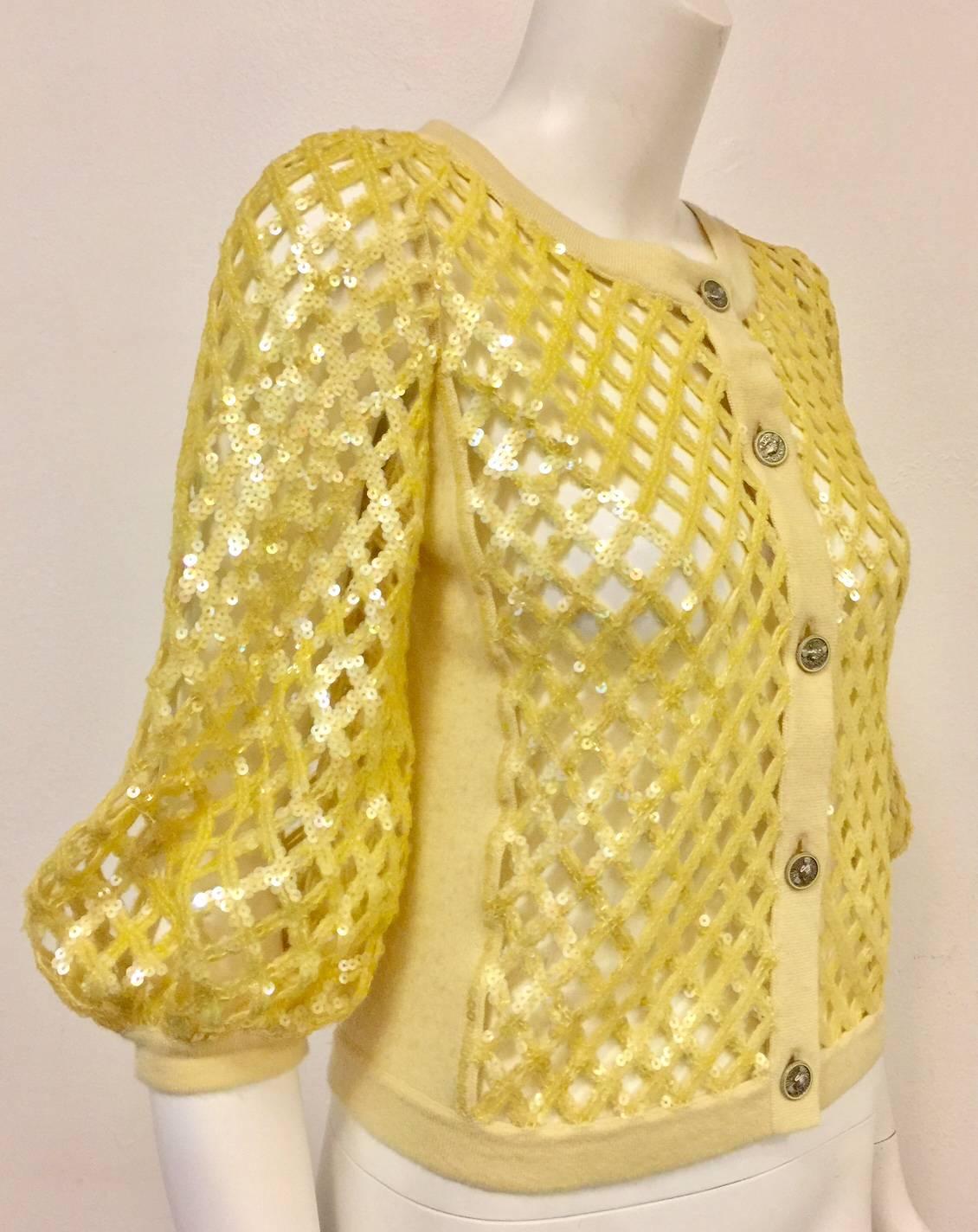 2008 Chanel Lemon Open Lattice Woven Cardigan goes from Spring Holiday to Cruise to Spring effortlessly.  Features ultra-luxurious cashmere, iridescent sequins allover, and pouf bracelet length sleeves with banded hem.  5-button closure.  Look