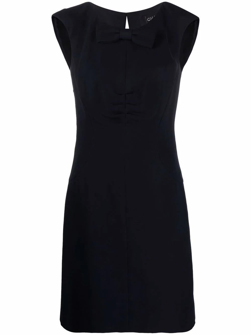 Chanel Navy silk dress featuring a detachable front bow, back neck slit, center back zip opening, with sides bra wires, full silk lining.
Composition: 100% Silk 
Lining: 100% Silk 
Circa 2008
Label size 36fr/ US4/ UK8
In good vintage condition. Made