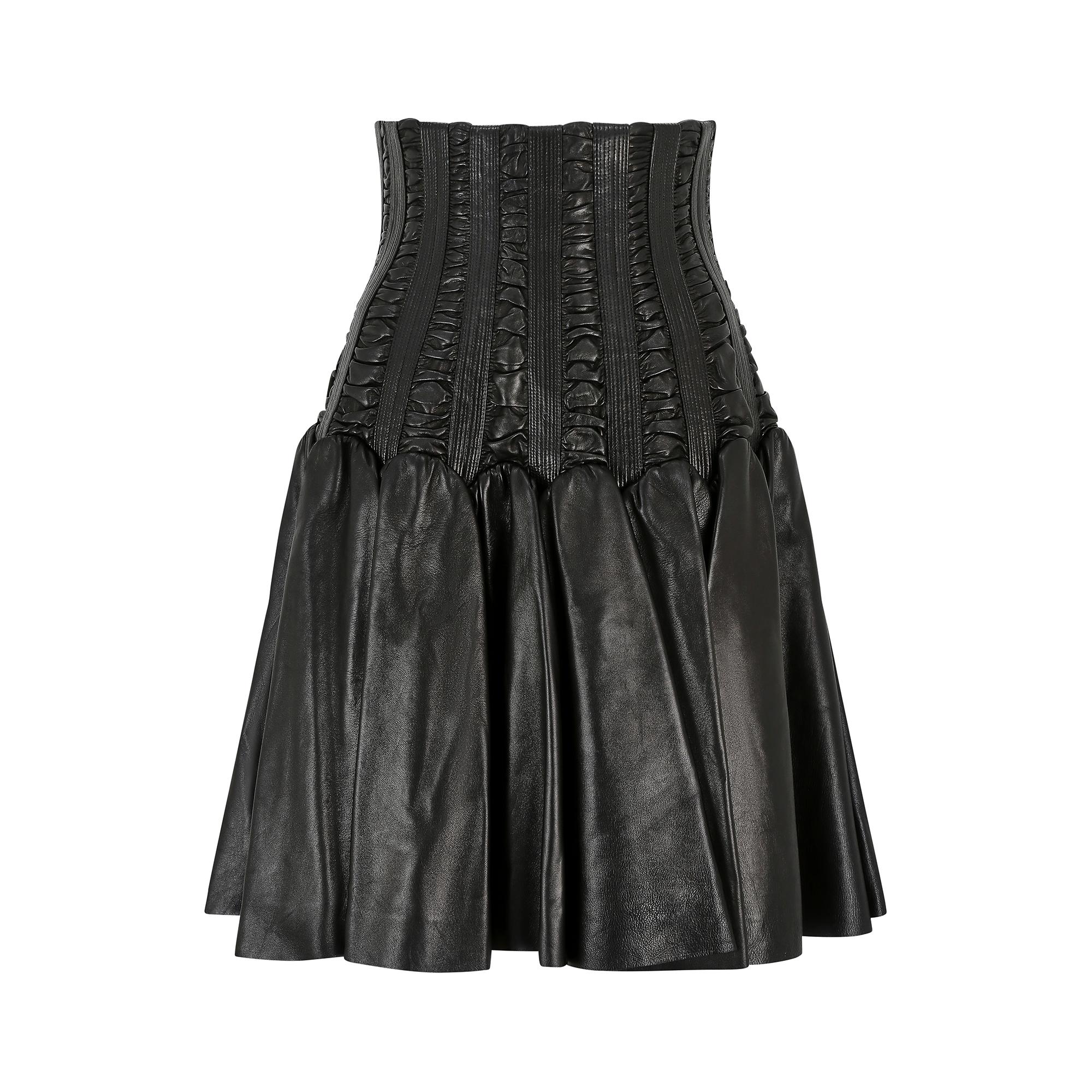 This documented 2008 Autumn/Winter collection skirt is by the renowned French couturier Azzedine Alaia shortly after he bought back his company from Prada in 2007.  Made of black lambs leather, the skirt features a high waisted, corset style