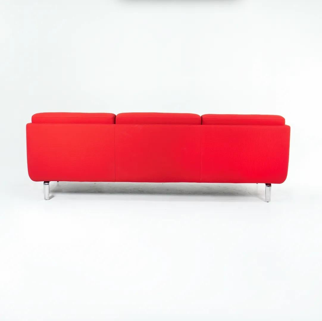This is a ‘Gaia’ sofa, designed by Arik Levy for Bernhardt Design in 2008. Its frame is composed of polished aluminum, and it has a molded-foam seat and back. The upholstery is done in a lovely red fabric. It is surprisingly comfortable while