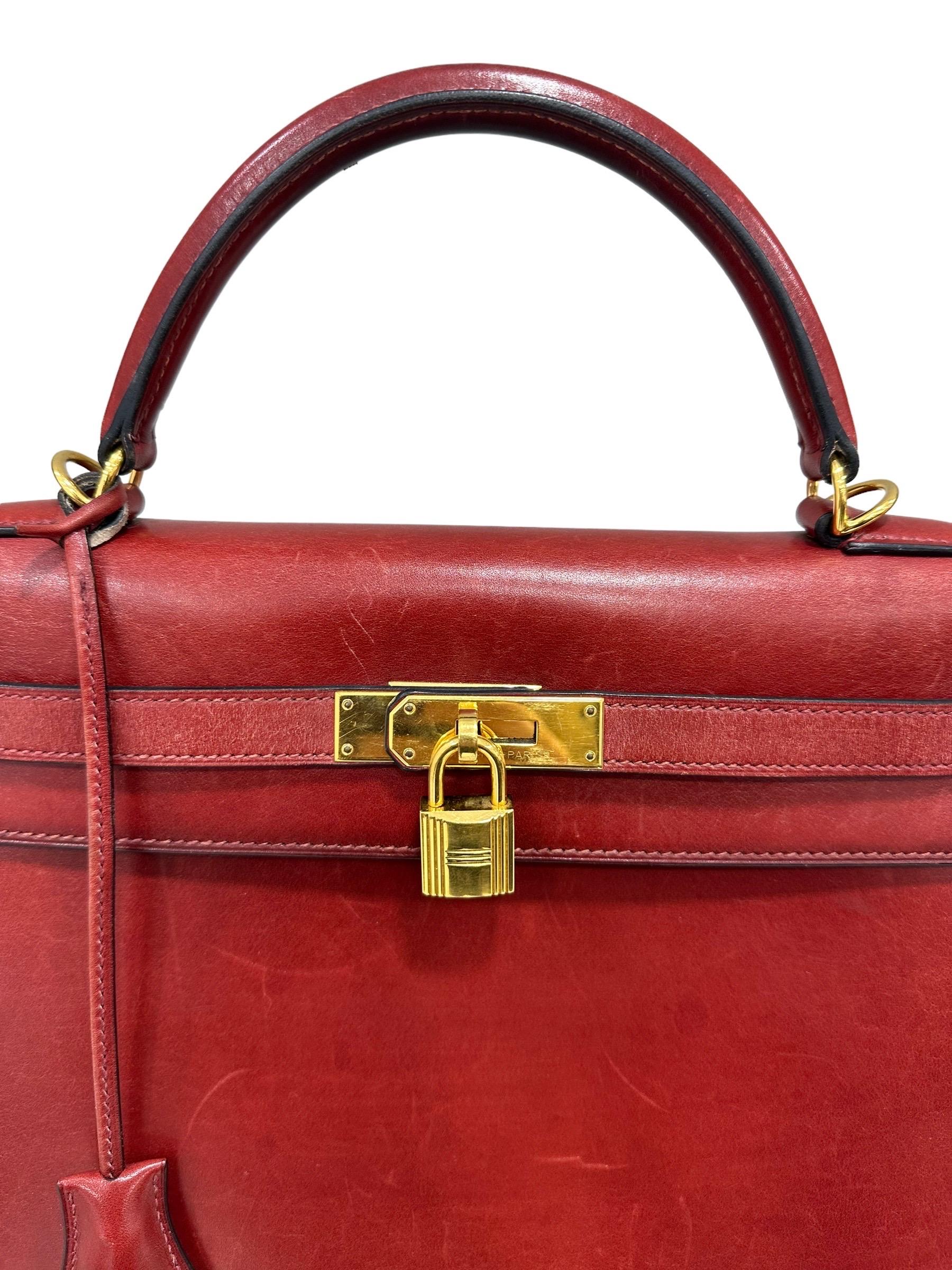 Bag signed Hermès, model Kelly, size 32, made in Box Calf leather, very smooth and rigid, in the Rouge H colorway with gold hardware. Equipped with the classic flap with interlocking closure with horizontal band, padlock and keys. Equipped with a