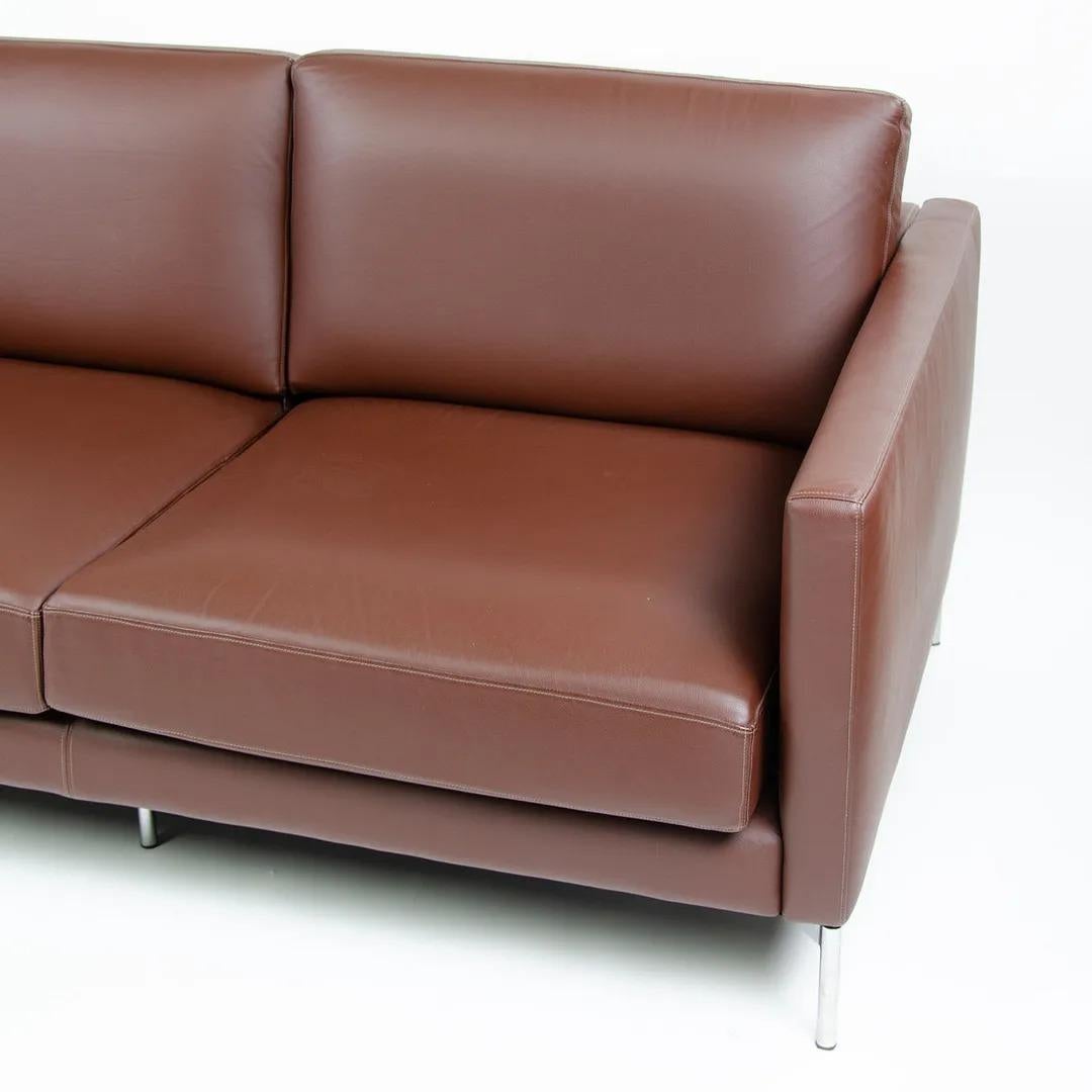 This is a Divina Two-Seater Settee, designed by Piero Lissoni for Knoll in 2001. This example dates to 2008. The piece is upholstered in a chocolate-brown leather, likely Volo leather, and has chromed steel legs.

This settee measures 35.5 inches