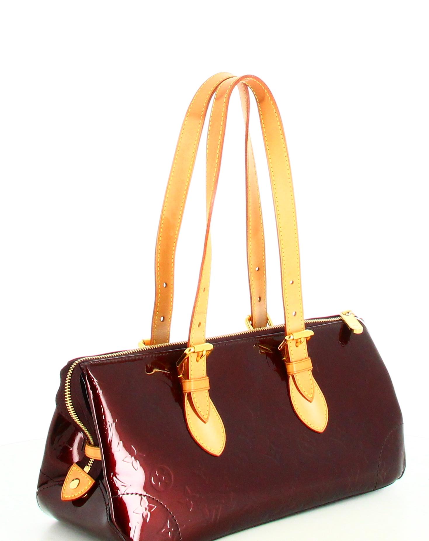 2008 Louis Vuitton Monogram Vernis Rosewood Avenue Handbag

- Good condition. Shows signs of wear over time. 
- Louis Vuitton Handbag 
- Burgundy patent leather 
- Brown leather hanses 
- Small pocket on back of bag 
- Interior: brown fabric plus
