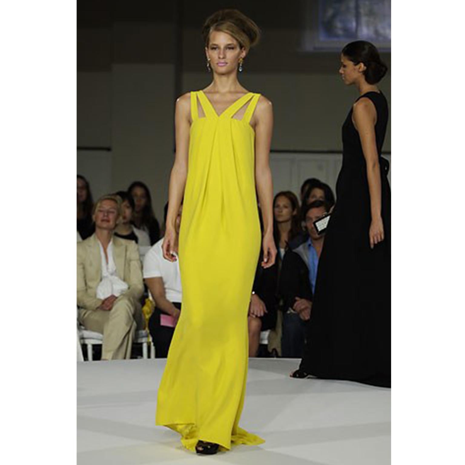This is a gorgeous vintage Oscar de la Renta dress that was featured in his 2008 Resort wear collection. This evening gown is in a lovely shade of yellow silk and is fully lined. We love the way this incredible dress is cut, with its dramatic
