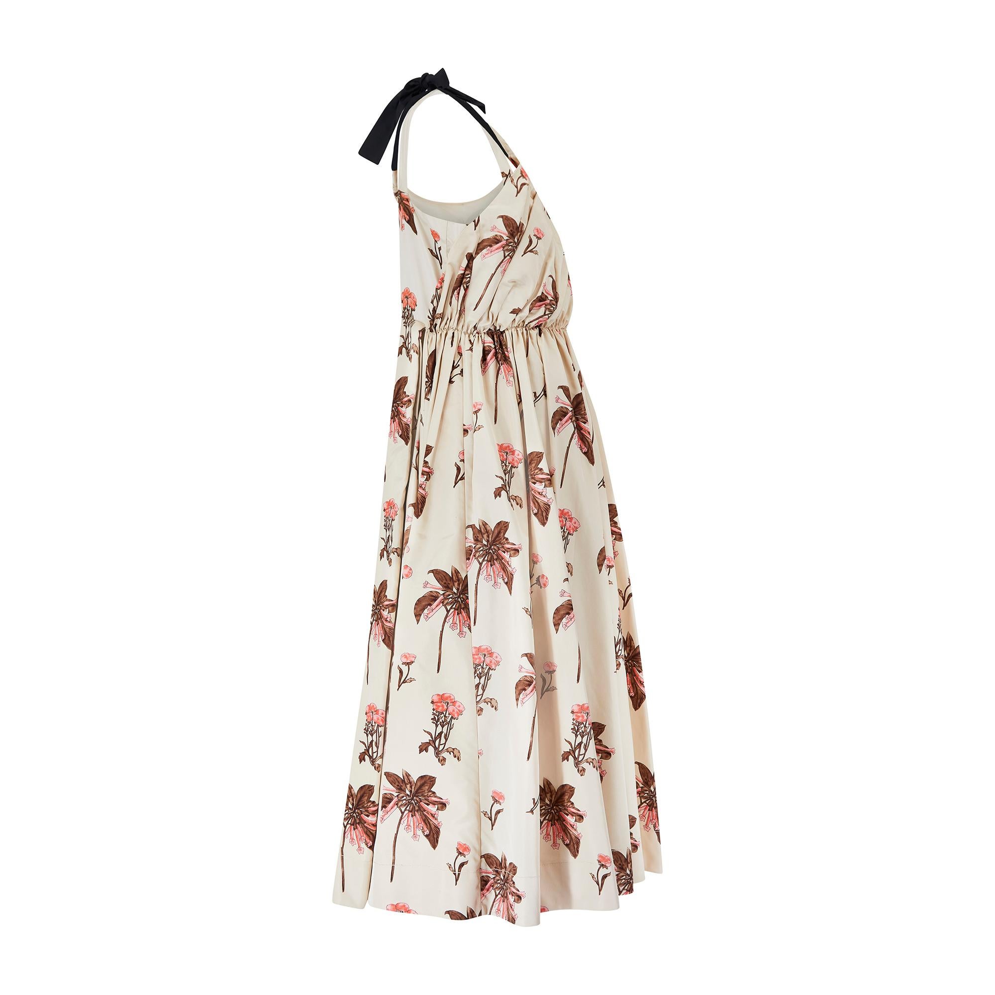 This decadent Prada gown displays all the elevated, feminine trademarks that have become a part of Miuccia Prada’s signature style.  From the 2008 Resort collection, this was the first look and styled with towering crimson heels. Tailored from