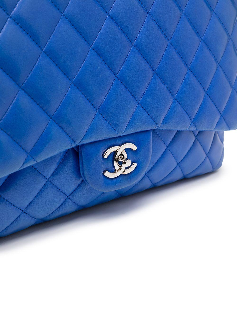 The perfect airport bag, store all your essentials , plus more in this vintage pre-owned blue lambskin maxi double flap, from 2009-2010. Featuring the classic Chanel diamond quilting and silver iconic 'CC' logo, the turn-lock closure opens to reveal