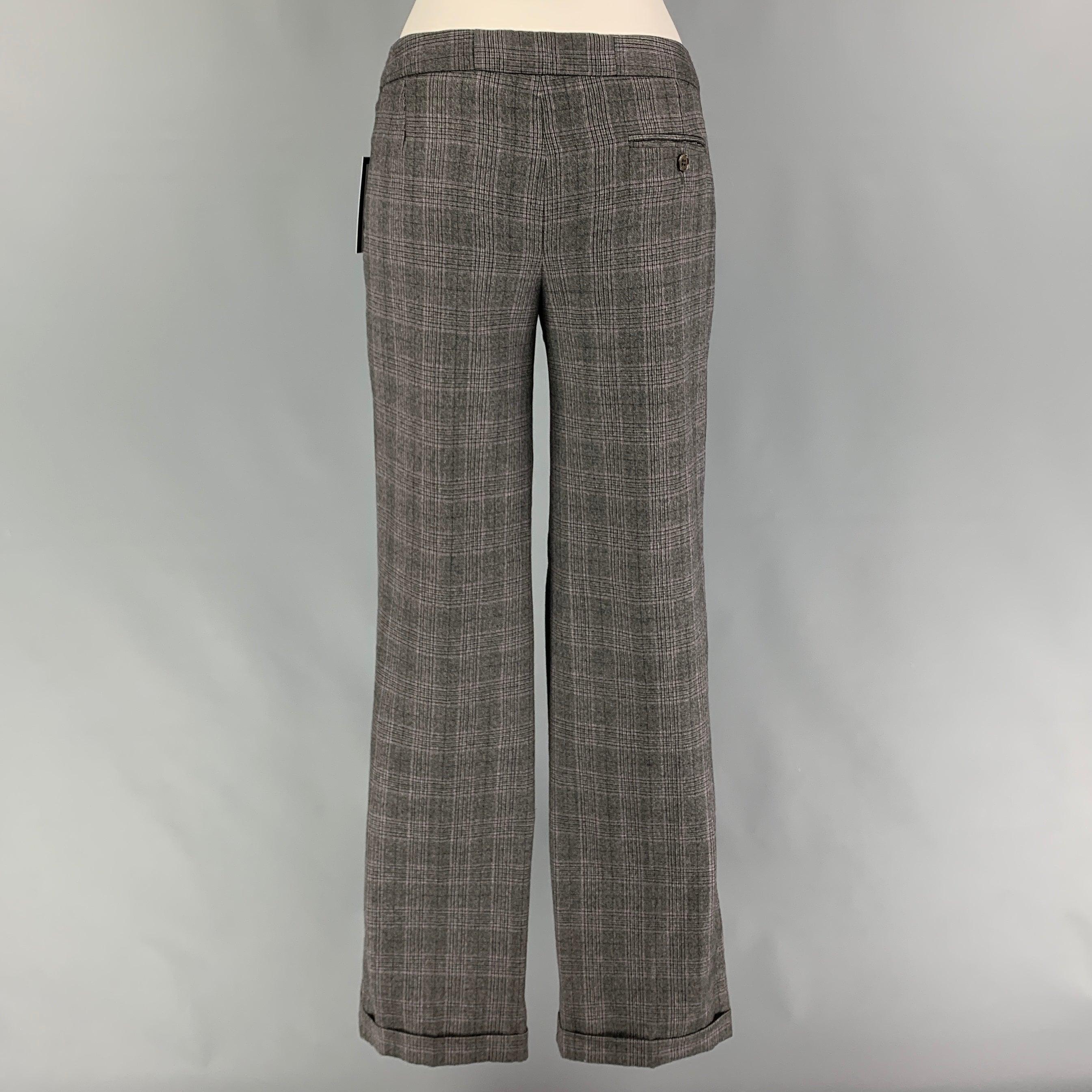 2009 by ALEXANDER McQUEEN dress pants comes in a grey virgin wool featuring a flat front, cuffed leg, and a zip fly closure. Made in Italy.
Very Good
Pre-Owned Condition. Pants have been professionally altered. Small mark at back left leg. As-Is. 