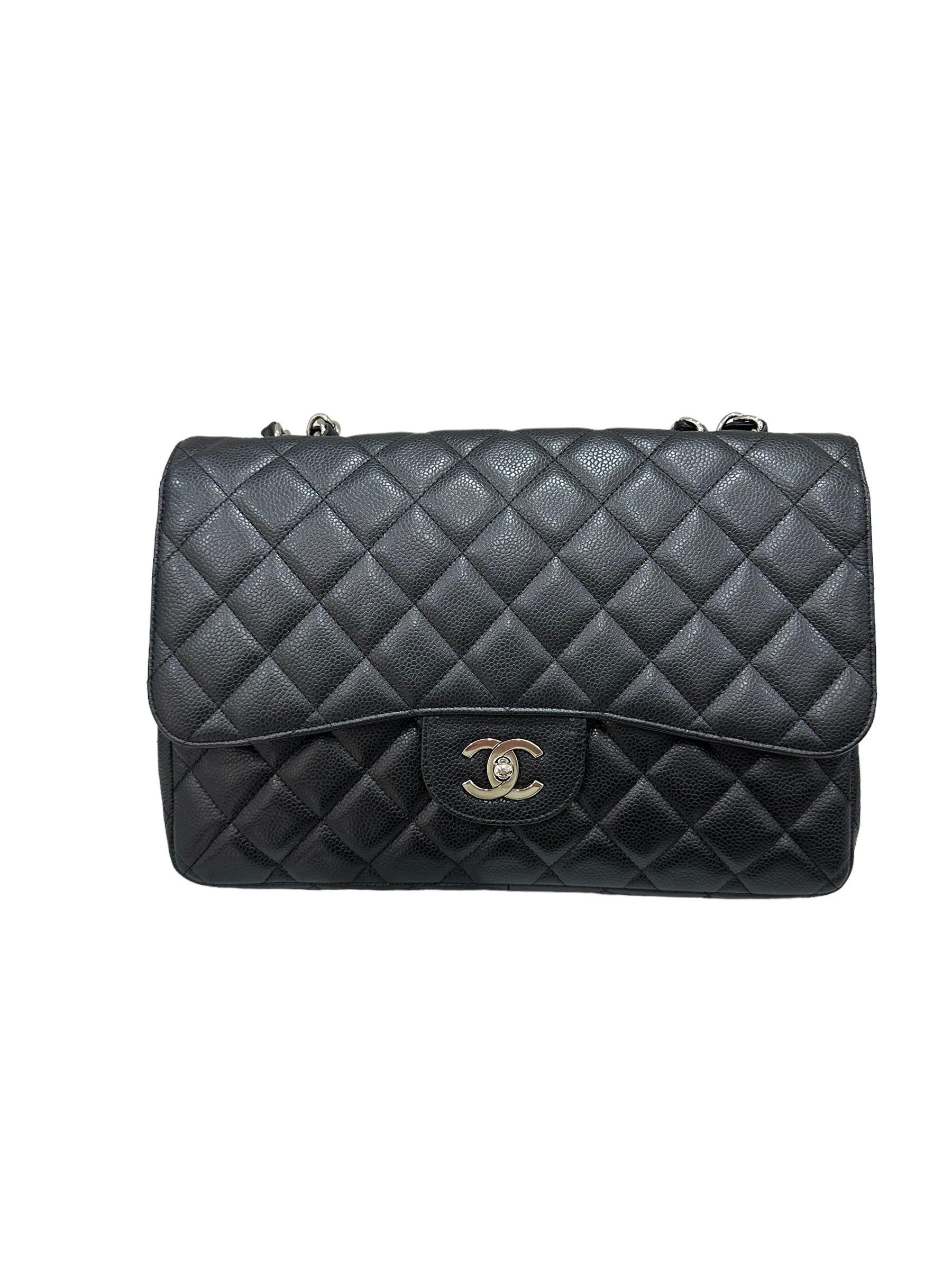 Chanel signed bag, Jumbo model, made of black cavier leather with silver hardware. Equipped with a flap with twist lock closure with CC logo, internally lined in smooth black leather, quite roomy. Equipped with a braided leather and chain shoulder