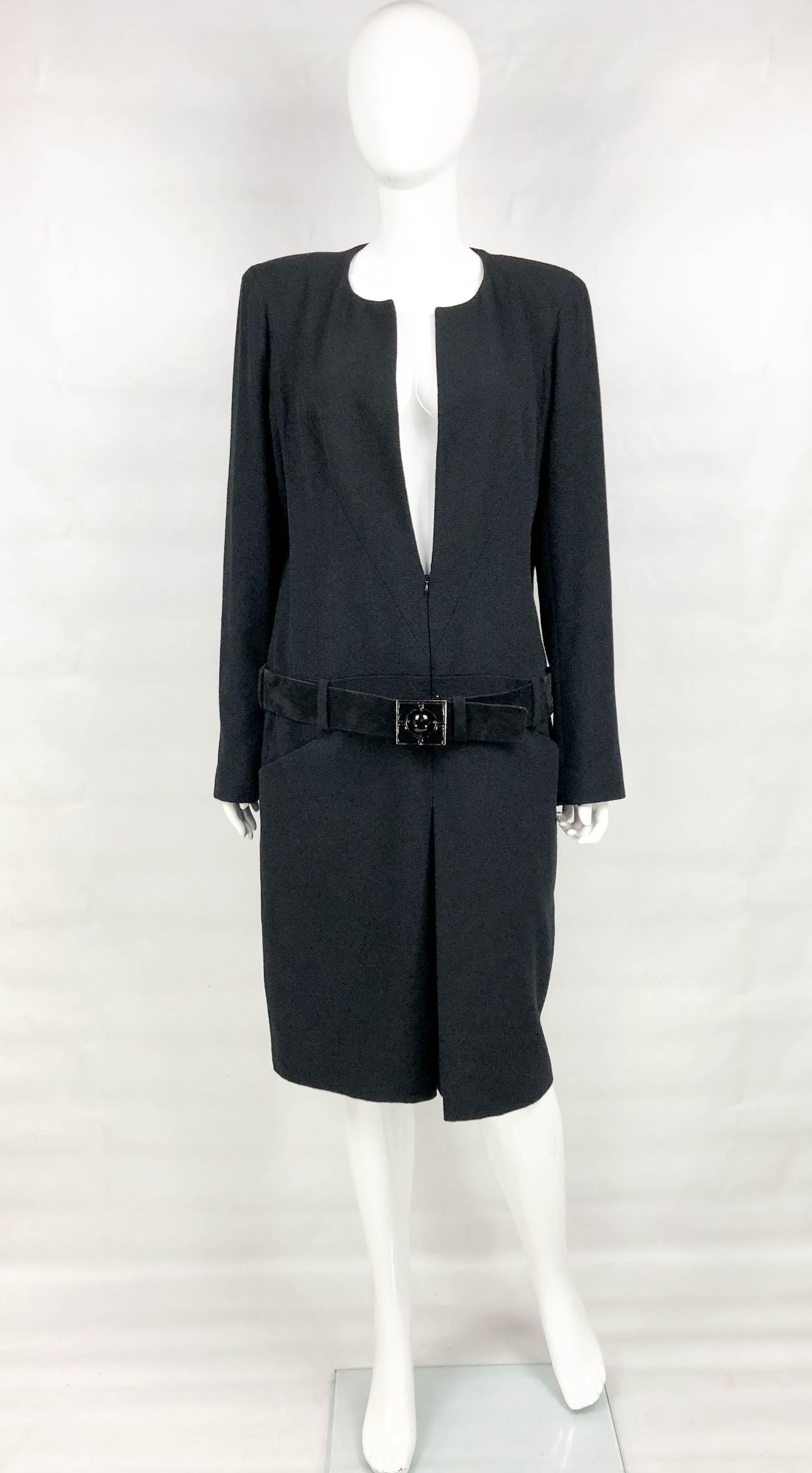 Chanel Runway Black Wool Belted Dress Coat. This very stylish piece by Chanel was crafted for the 2009 Autumn / Winter Collection. Please refer to photos for an identical piece being worn by a model on the runway. Made in black wool, it features a