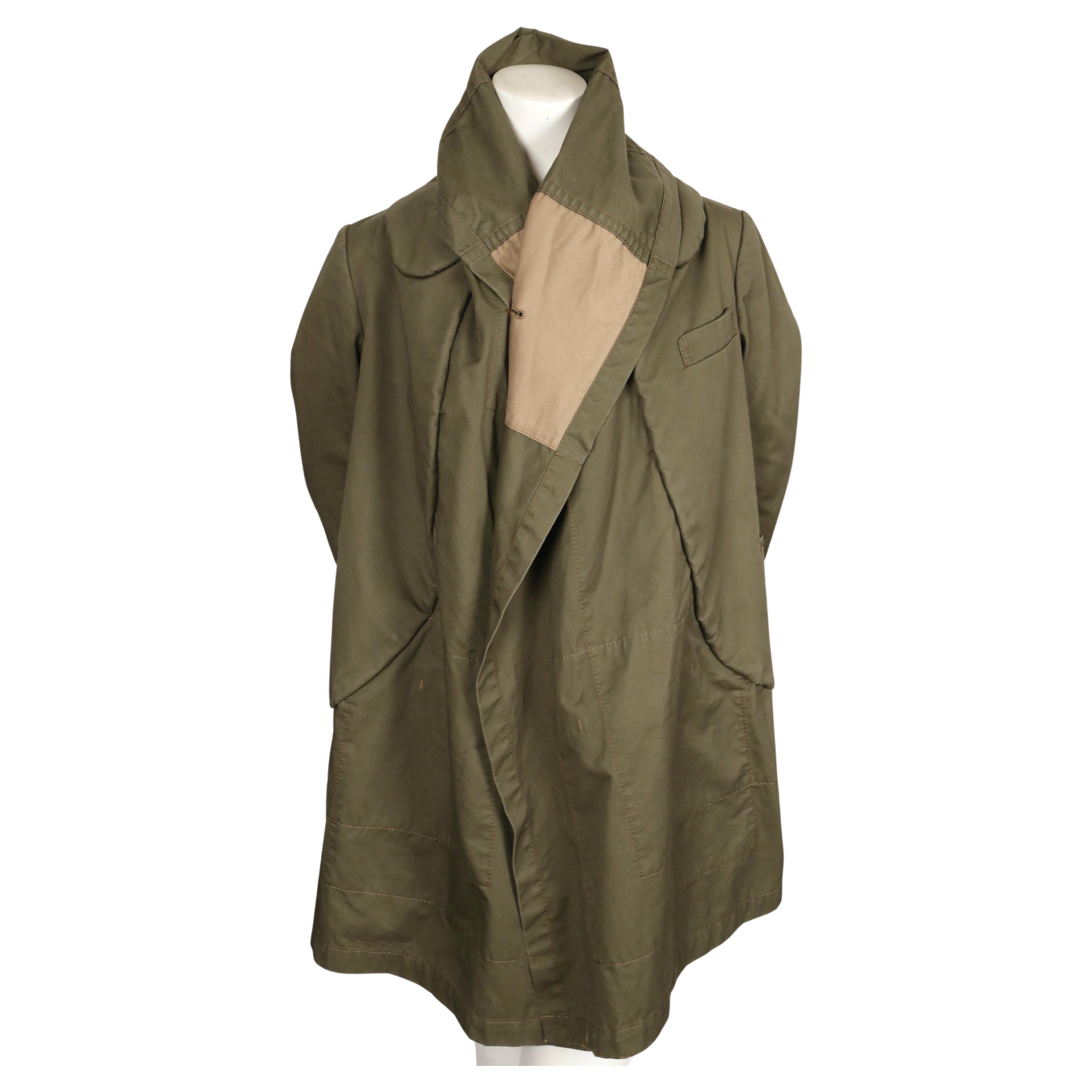 Very unique, army-green cotton coat with cropped sleeves from Comme Des Garcons exactly as seen on the fall 2009 runway. Appears as a coat worn over another coat in a classic 'visual pun' form from Rei Kawakubo for Comme Des Garcons.  Can be worn