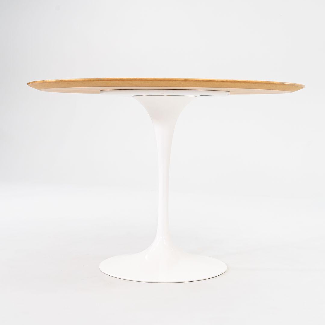 This is a Pedestal Dining Table, Model 173O, originally designed in 1956 by Eero Saarinen for Knoll. This particular piece was produced in the USA in 2009. The base is formed of molded cast-aluminum which is coated in a white satin finish. Its top