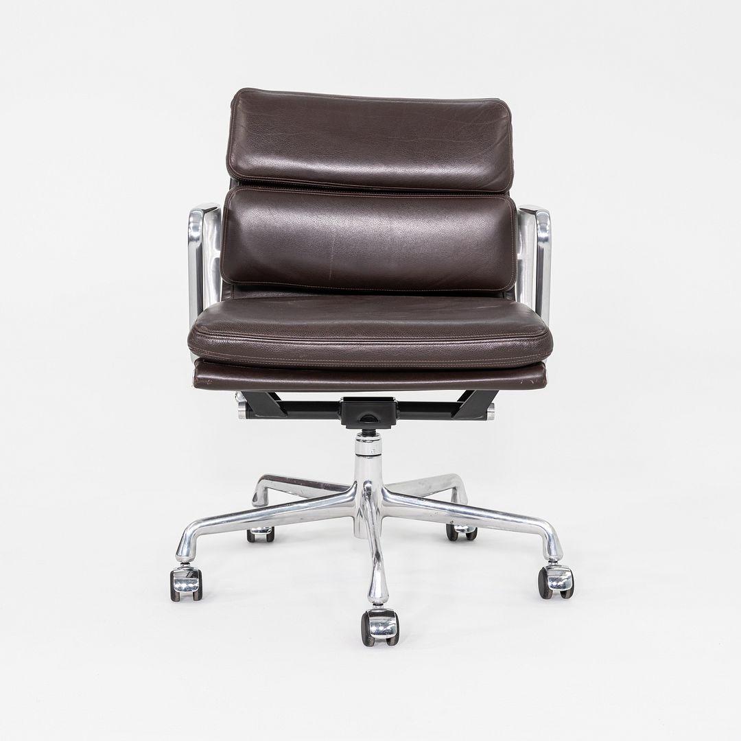 This is an Eames Aluminum Group Soft Pad Management Desk Chair, Model EA435, originally designed by Charles and Ray Eames for Herman Miller in 1969. These examples date to the year 2009. The design features a cast aluminum frame with 5-star bases on
