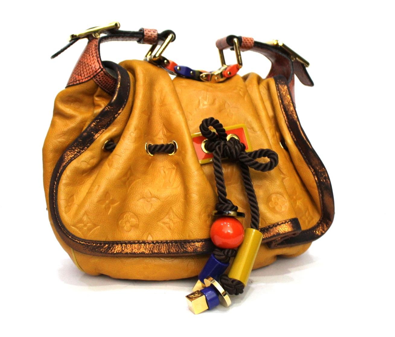 Louis Vuitton Kalahari  Monogram Pm Limited Edition, made of soft yellowleather full of colorful details. Equipped with a handle to wear it on the shoulder, flap closure, quite large inside.
Excellent condition, year 2009.