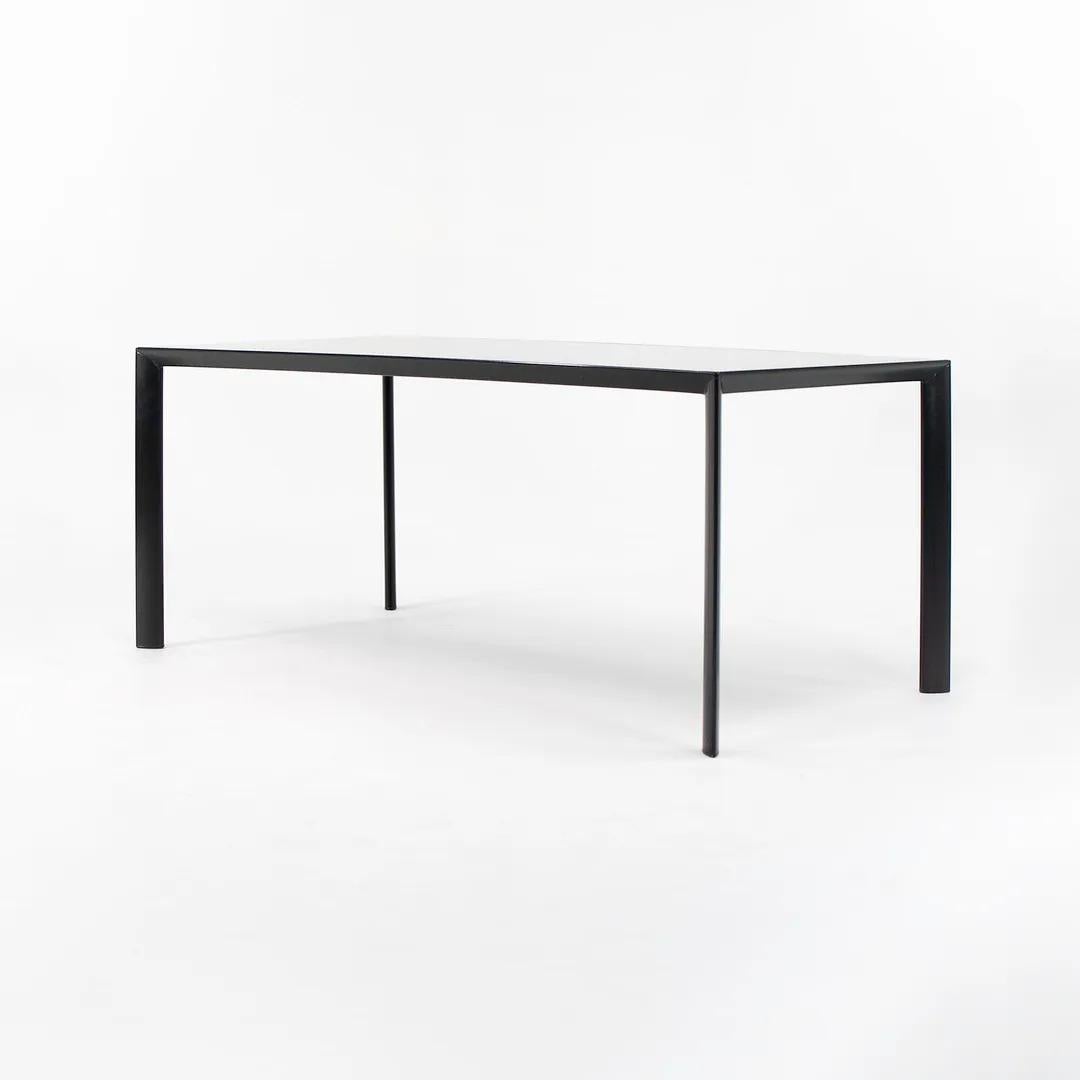 This is a RAM dining table / desk, designed by Decoma and produced by Porro in Italy. It is crafted from a beautiful heavy gauge steel and black glass top. The frame is powder coated. It's in terrific condition overall with some light wear from use.