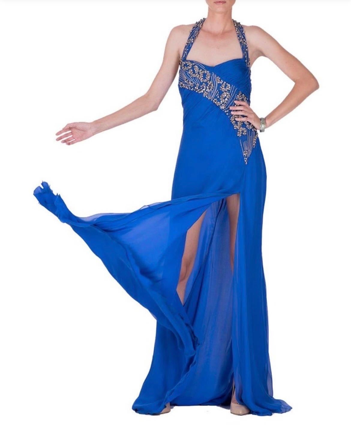 Versace's  gown is crafted from chiffon silk and finished with embroidery, chains, crystals and sexy thigh high slit.
Circa 2009
Fully lined.  
Content: 95% silk, 5% nylon. Lining: 100% silk    
It size 42 - US 6
Made in Italy   
Brand new, with