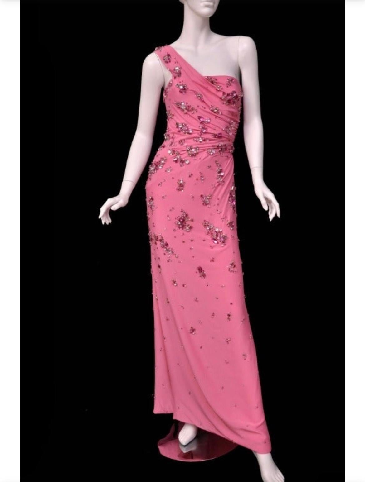 VERSACE DRESS  
Circa 2009
One-shoulder design, artfully hand embellished body with the best and biggest Swarovski crystals- ensure a stunning silhouette.   
Content: 100% silk 
IT Size 42 - US 6  
Made in Italy  
Brand new, with tags. 
Excellent