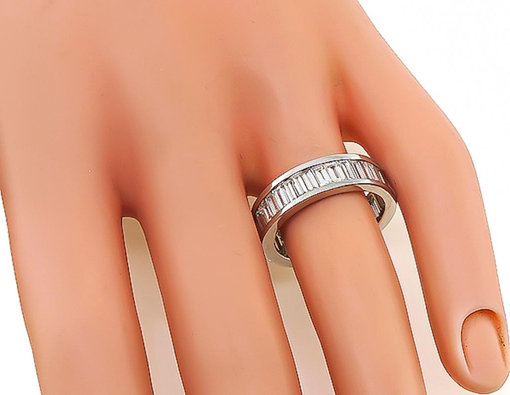 This is an elegant 18k white gold eternity wedding band. The band is set with sparkling baguette cut diamonds that weigh approximately 2.00ct. The color of these diamonds is H with VS1 clarity. The band measures 6mm in width and weighs 4.6 grams.
