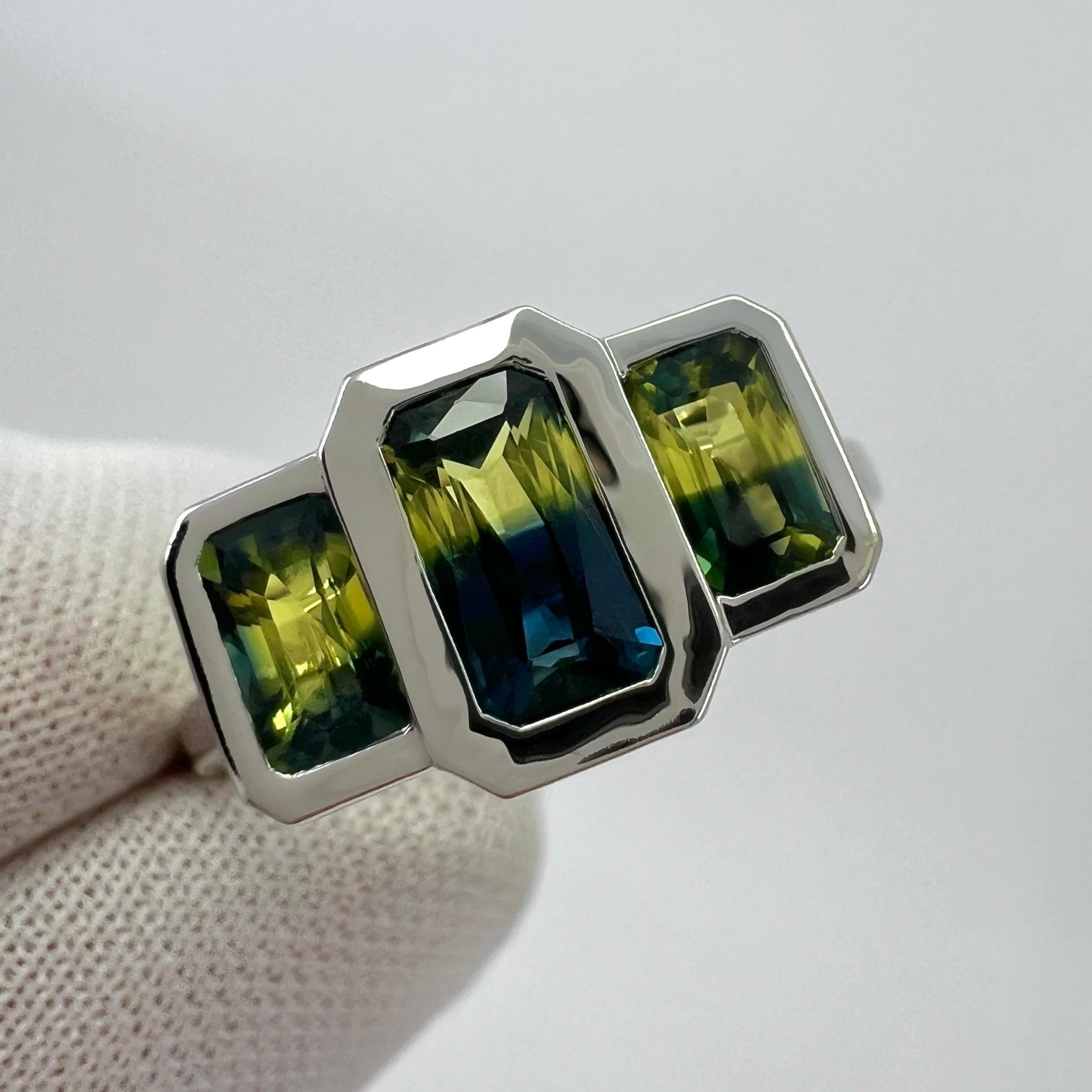 Natural Bi Colour Yellow & Blue Australian Sapphire 18k White Gold Three Stone Ring.

A three stone suite of natural Australian sapphires, all with a unique blue & yellow bi colour effect. Very rare and stunning to see, similarly seen in ametrine