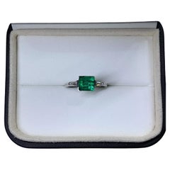 2.00ct Diamond baguette emerald green trilogy engagement ring in platinum.