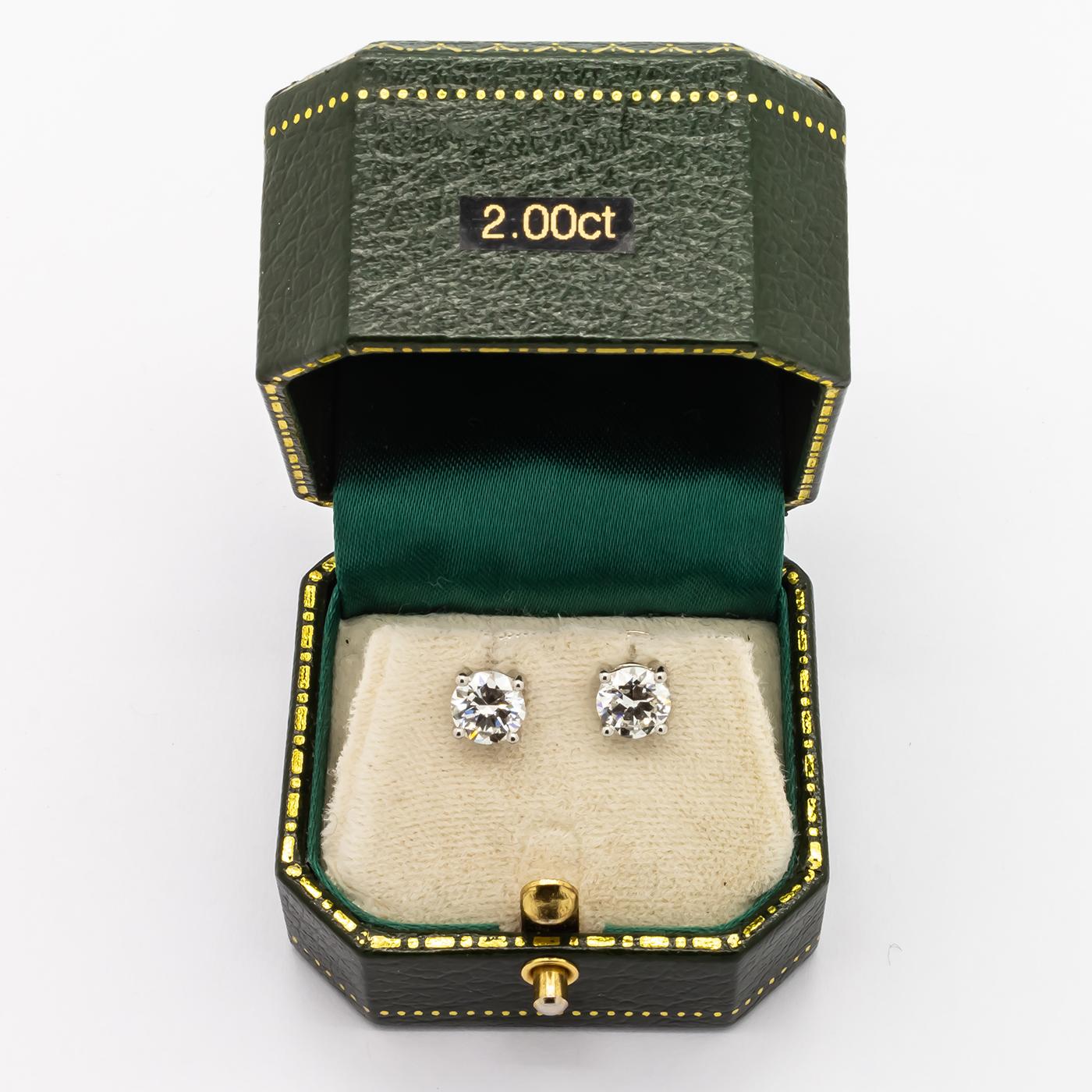 A pair of approximately 2.00ct diamond ear studs, set with round brilliant diamonds, weighing approximately 1.00ct each, in four claw settings and alpha clips, mounted in platinum.