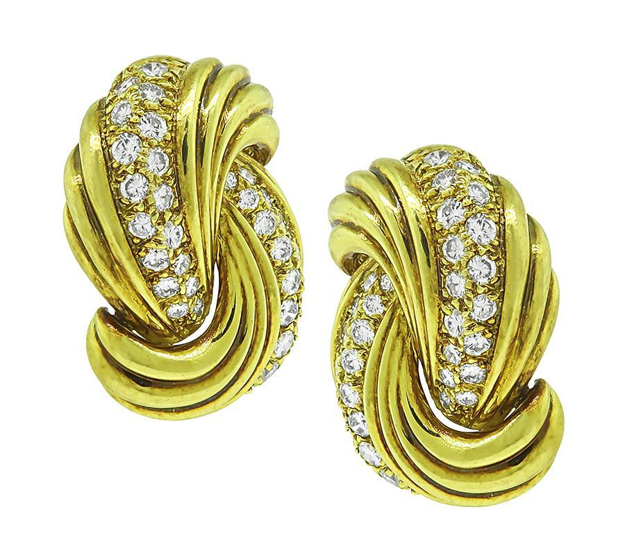 This is an elegant pair of 18k yellow gold earrings. The earrings feature sparkling round cut diamonds that weigh approximately 2.00ct. The color of these diamonds is F-G with VS clarity. The earrings measure 28.5mm by 22mm and weigh 24.2 grams. The