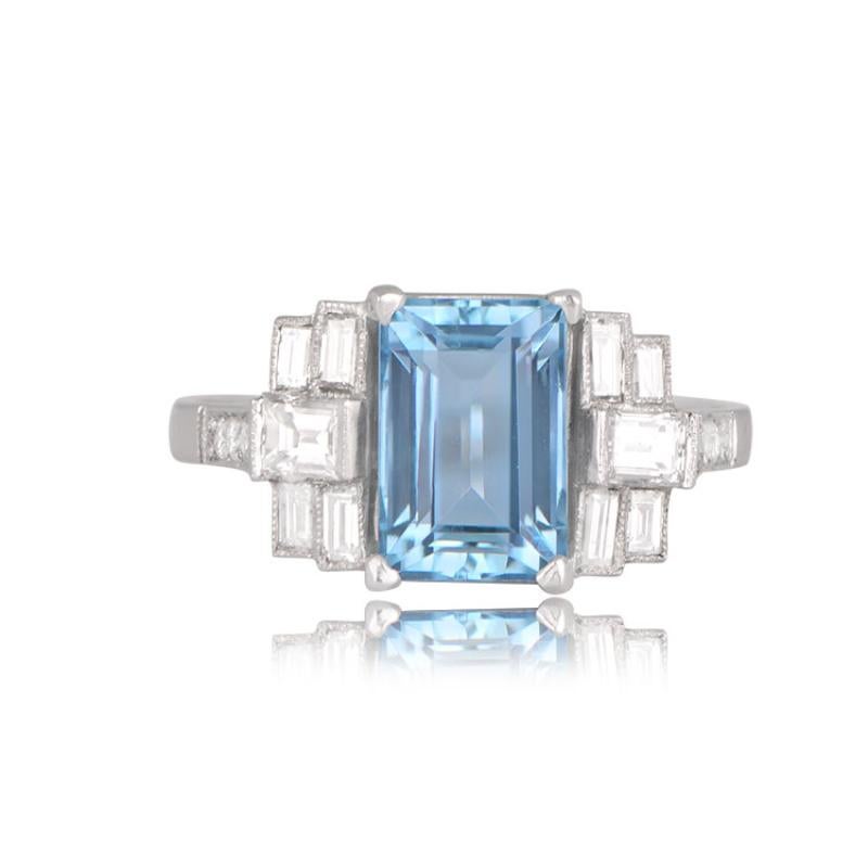 Featuring a deep saturation, this ring holds a natural emerald-cut aquamarine weighing around 2.00 carats. Baguette-cut diamonds frame the center stone, and diamond-adorned shoulders complete the look. The total diamond weight is about 0.88 carats.