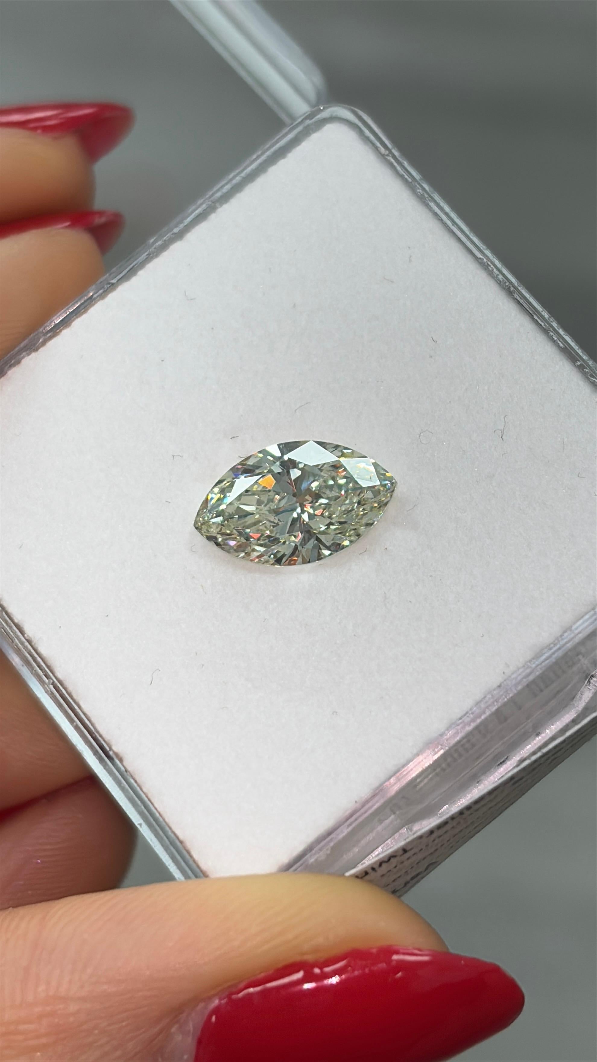 This rare 2.00 carat fancy light yellow-green marquise cut diamond offers a beautiful blend of softness and vibrancy. With its elongated silhouette and graceful curves, the marquise shape brings a timeless, elegant feel to this unique