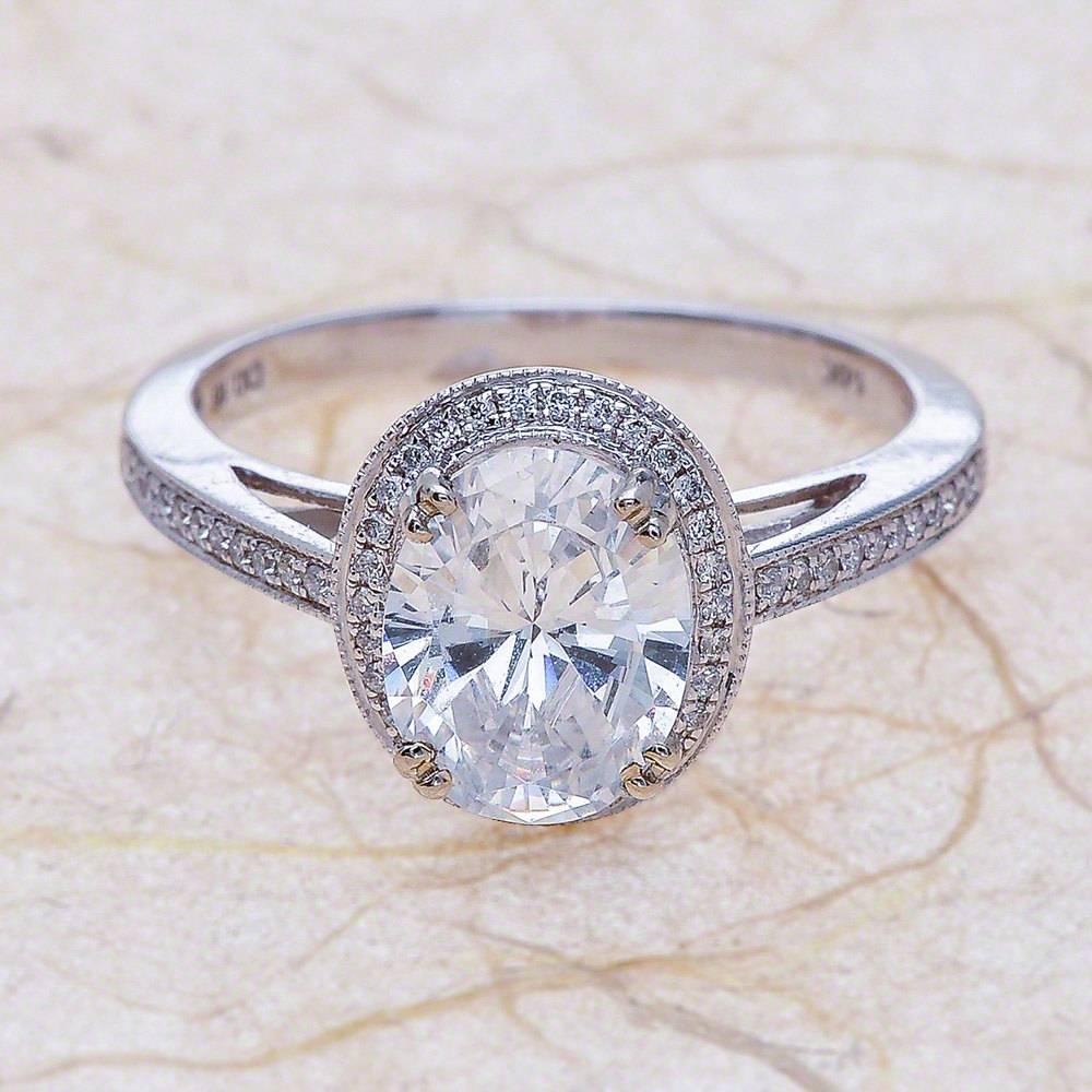 - Center Stone: Oval Cut Moissanite 9x7mm (2.00ct)
- Side Stones: Round Cut Diamonds 0.30ctw / Graded G SI1
- Metal: 14K White Gold

This piece is made-to-order. Please allow up to 7 Business Days to accomplish.