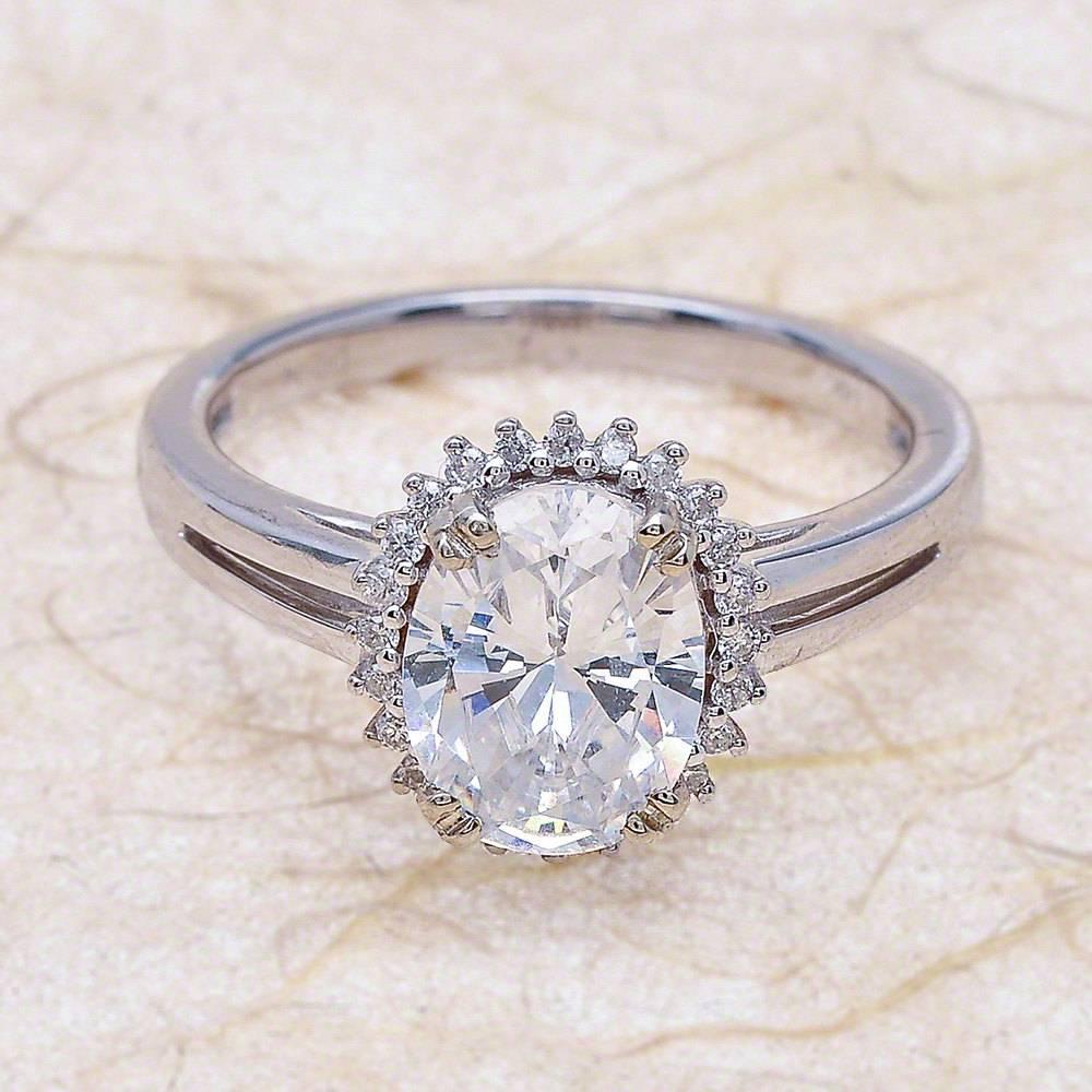 - Center Stone: Oval Cut Moissanite 9x7mm (2.00ct)
- Side Stones: Round Cut Diamonds 0.30ctw / Graded G SI1
- Metal: 14K White Gold

This piece is made-to-order. Please allow up to 7 Business Days to accomplish.