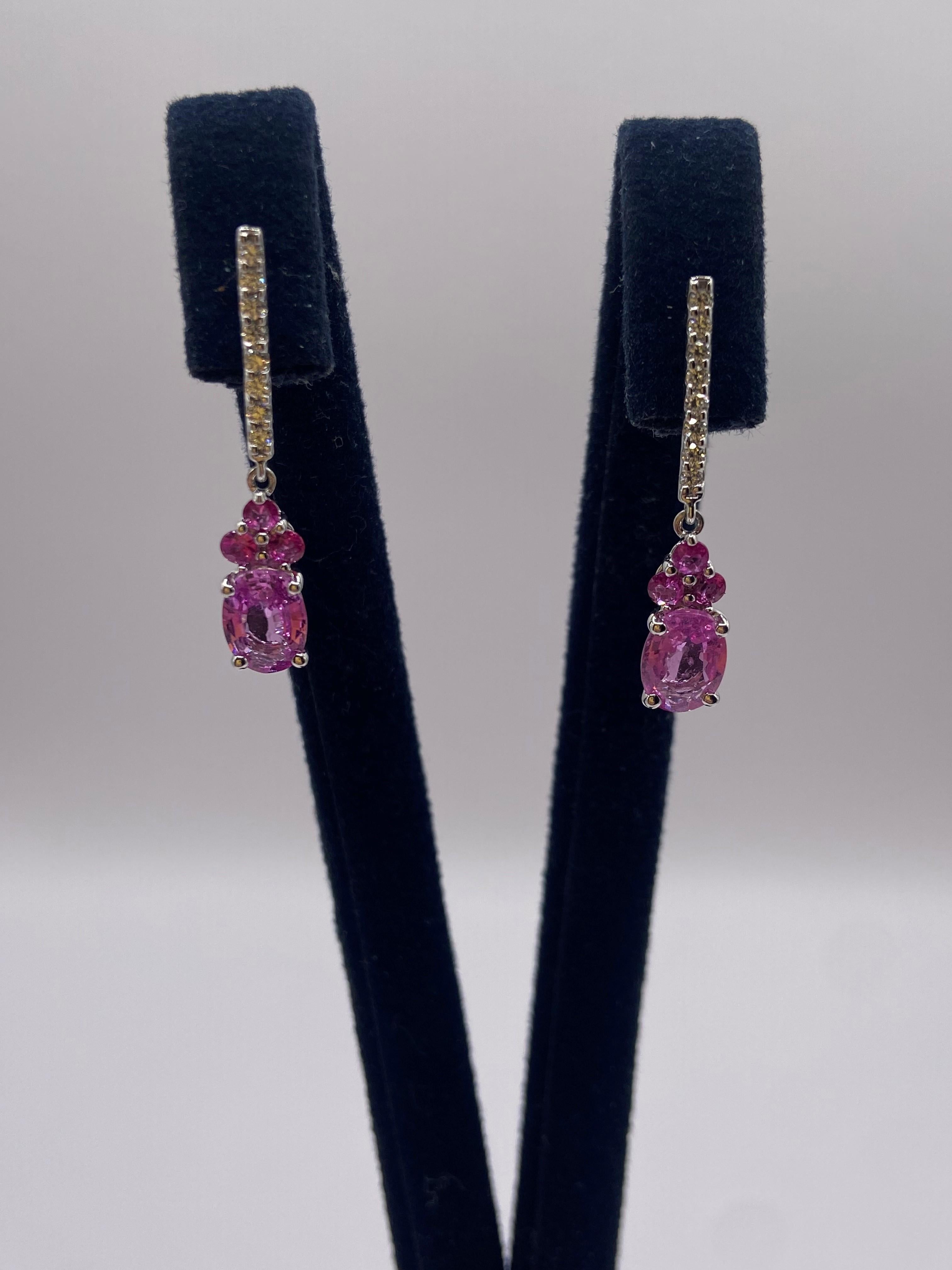 • 14KT White Gold
• 2.00ctw
•  Earrings are sold as a pair (2 pieces)

• Number of Oval Cut Pink Sapphires: 2
• Carat Weight: 1.50ctw
•  Stone Size: 7 x 5mm

• Number of Round Pink Sapphires: 6
• Carat Weight: 0.28ctw

• Number of Round Diamonds: